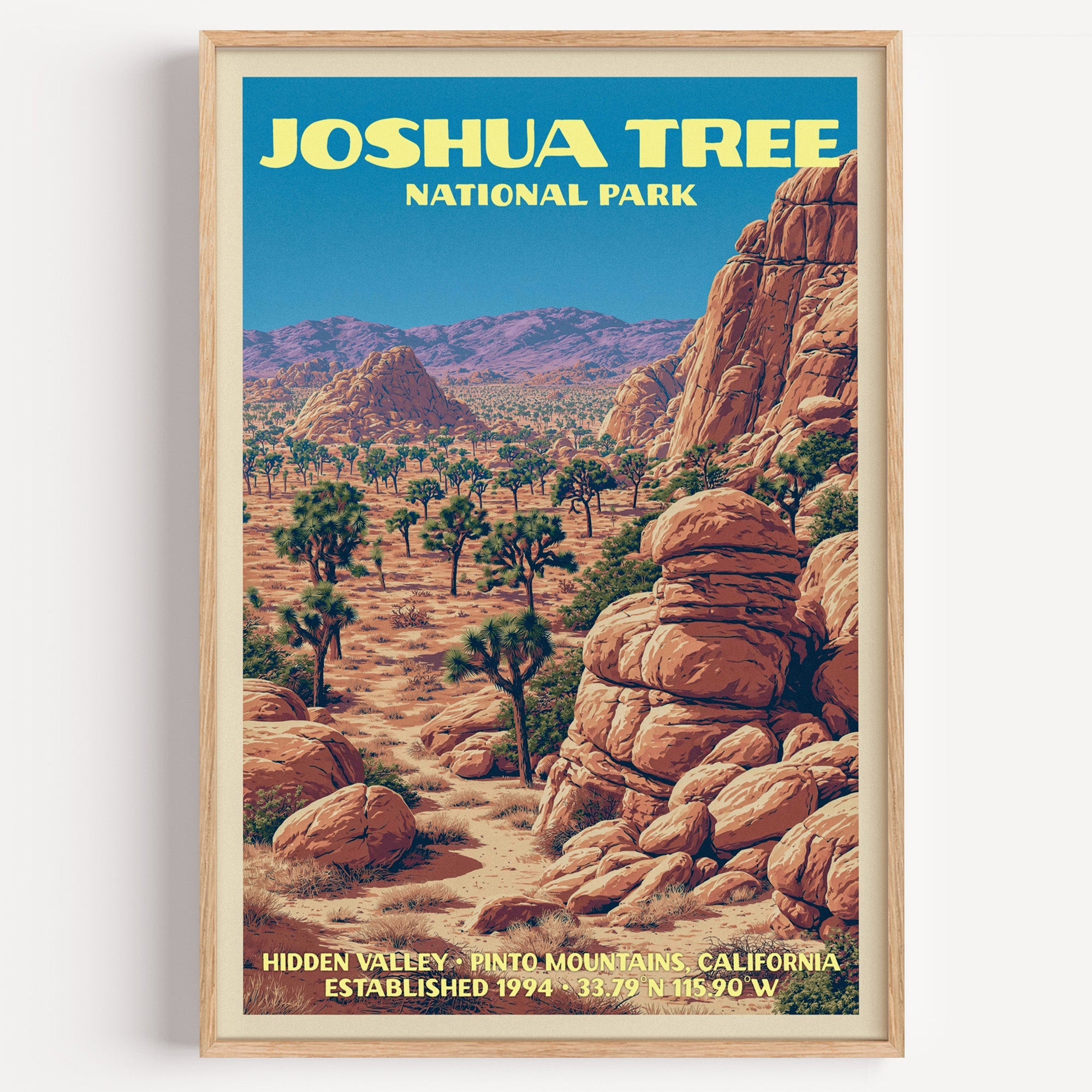 Hidden Valley Joshua Tree National Park vintage poster in a light oak frame on a plain white wall