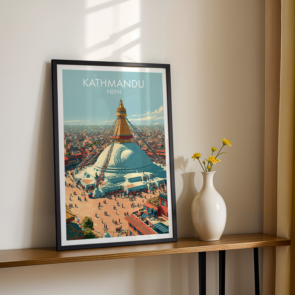 Black framed Kathmandu Nepal print on a narrow hallway console in sunlight, styled with yellow flowers