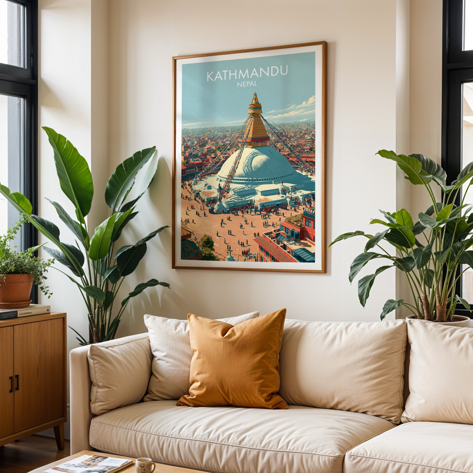 Framed Kathmandu Nepal wall art hanging above a cream sofa in a bright living room with tropical plants