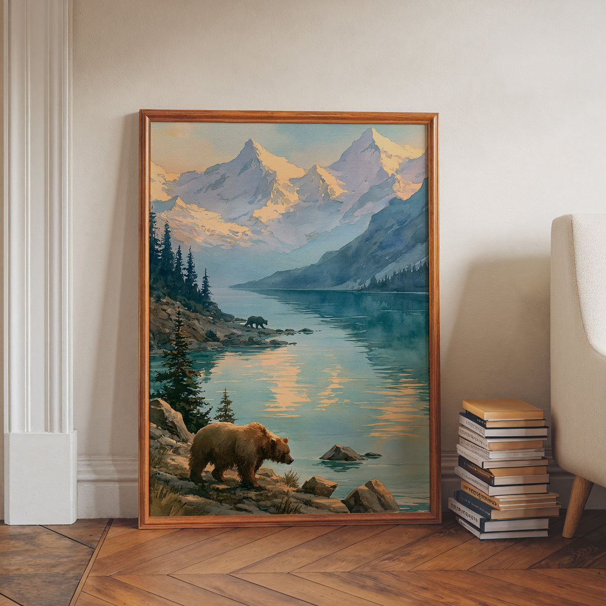 Katmai National Park watercolor print in a walnut frame leaning on a herringbone floor beside stacked books