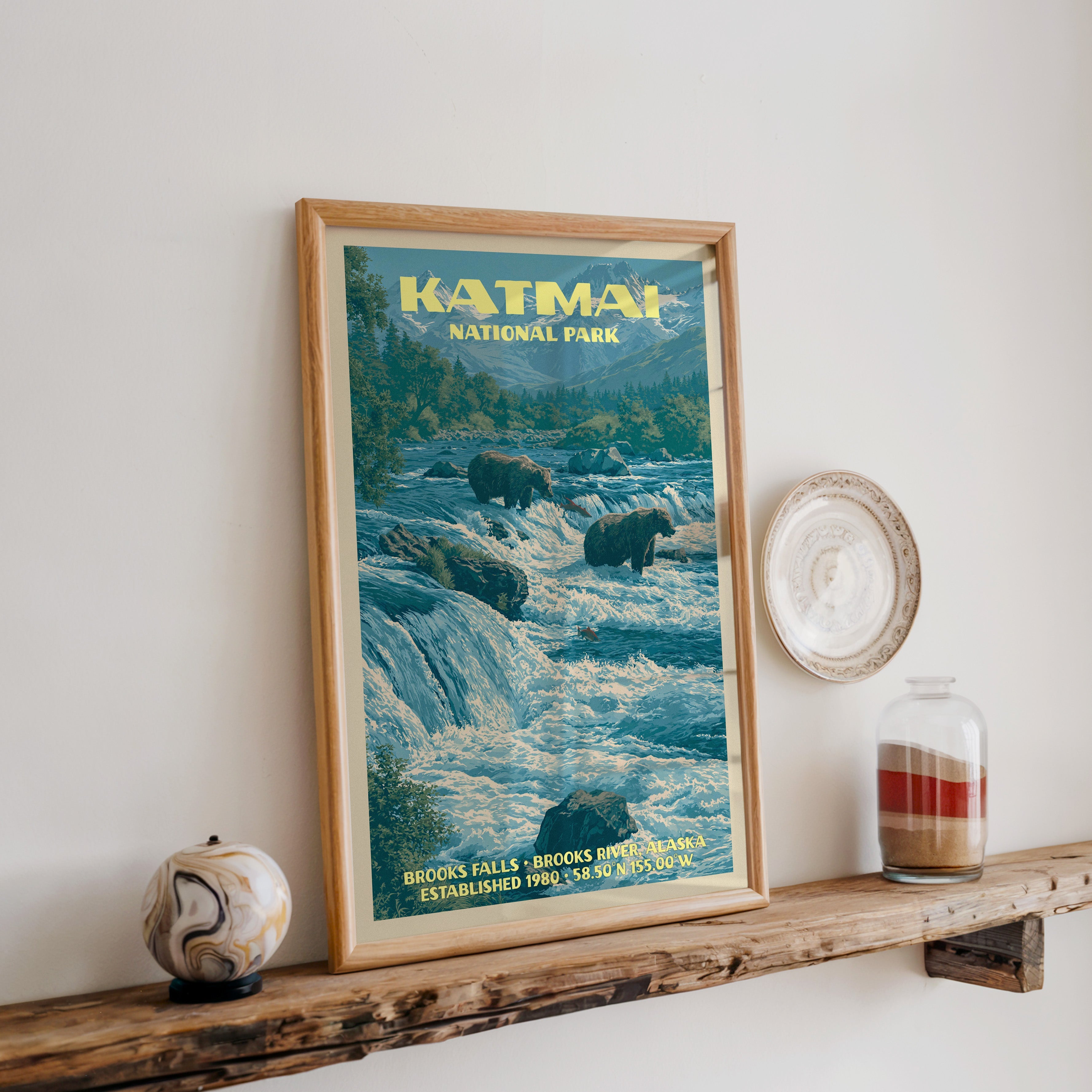 Katmai Brooks Falls print in oak, leaning on a reclaimed wood ledge with a marbled sphere and sand jar