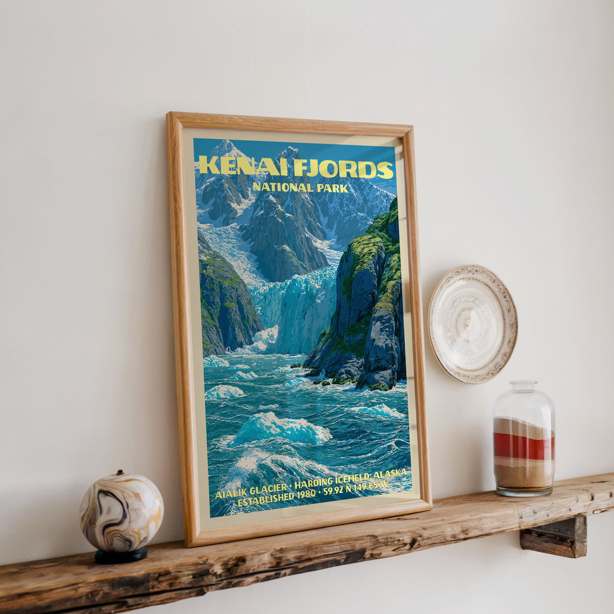 Kenai Fjords Aialik Glacier print in oak, leaning on a reclaimed wood ledge with a marbled sphere and sand jar