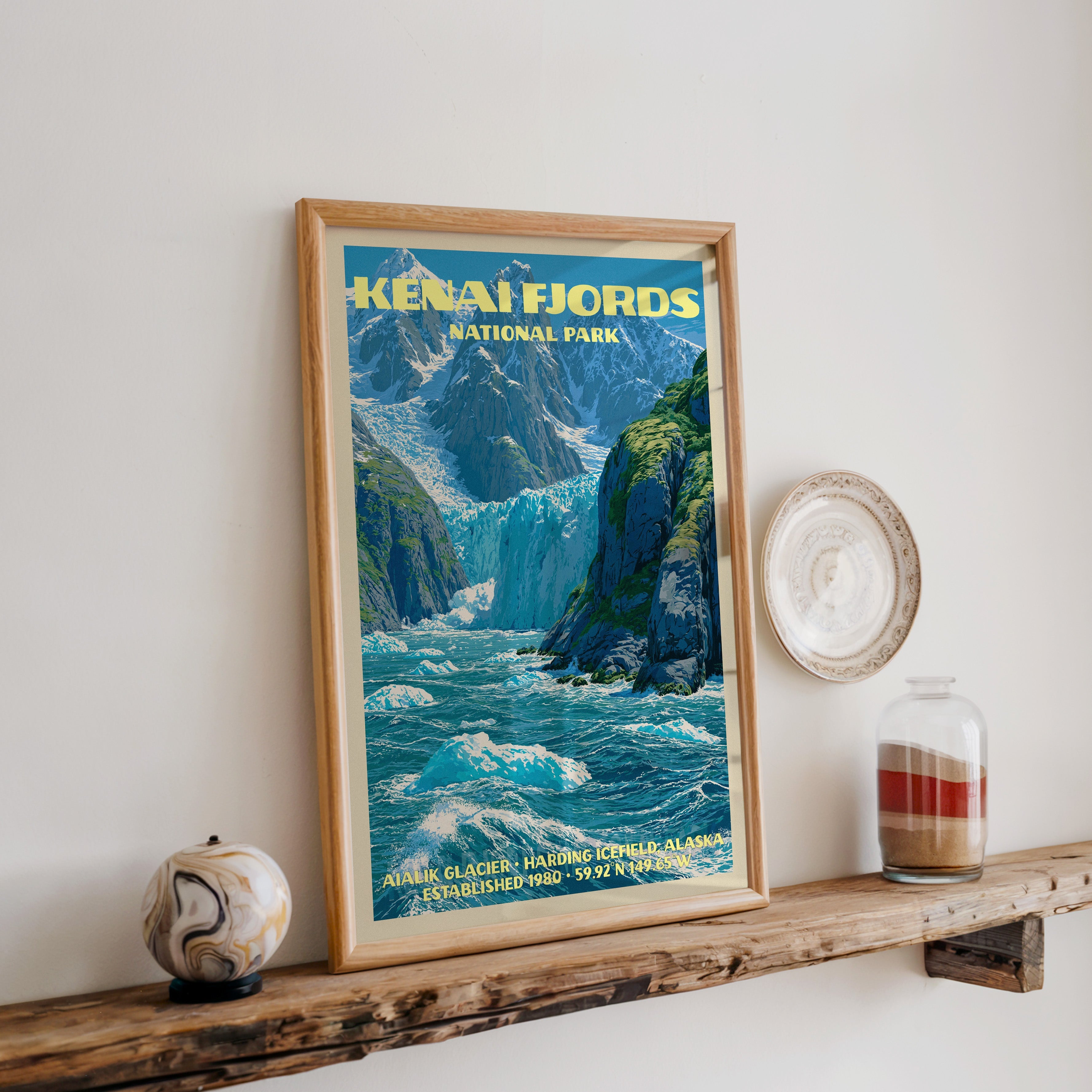 Kenai Fjords Aialik Glacier print in oak, leaning on a reclaimed wood ledge with a marbled sphere and sand jar