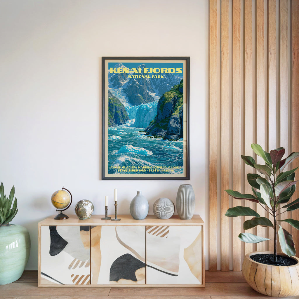 Kenai Fjords National Park poster in a black frame above a light wood sideboard by a slatted wall panel