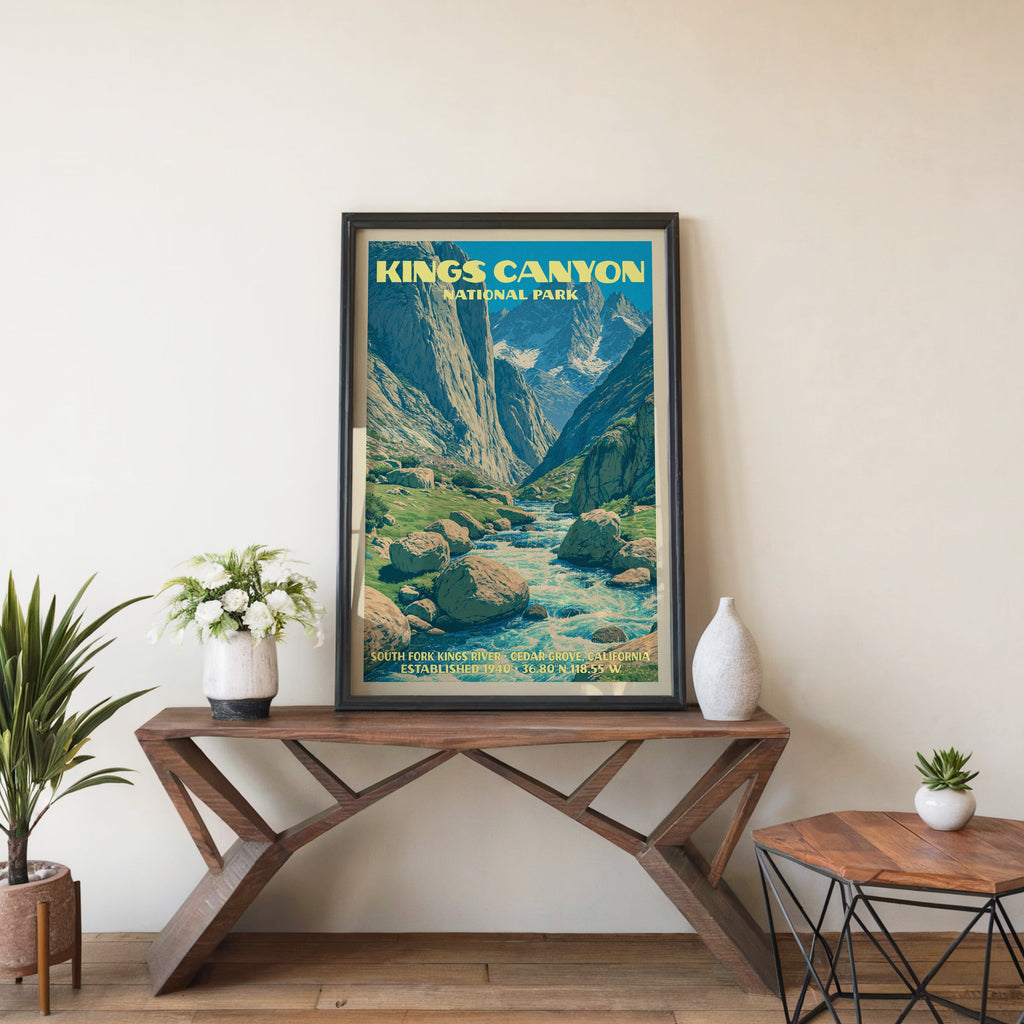 Kings Canyon river wall art in black, leaning on a walnut console with white anemones and a vase