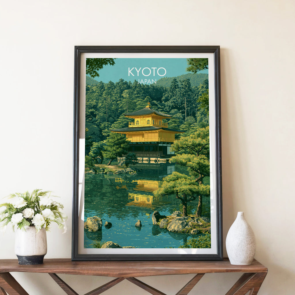 Kinkakuji Golden Pavilion Kyoto travel poster in a black frame on a wooden console table with white flowers