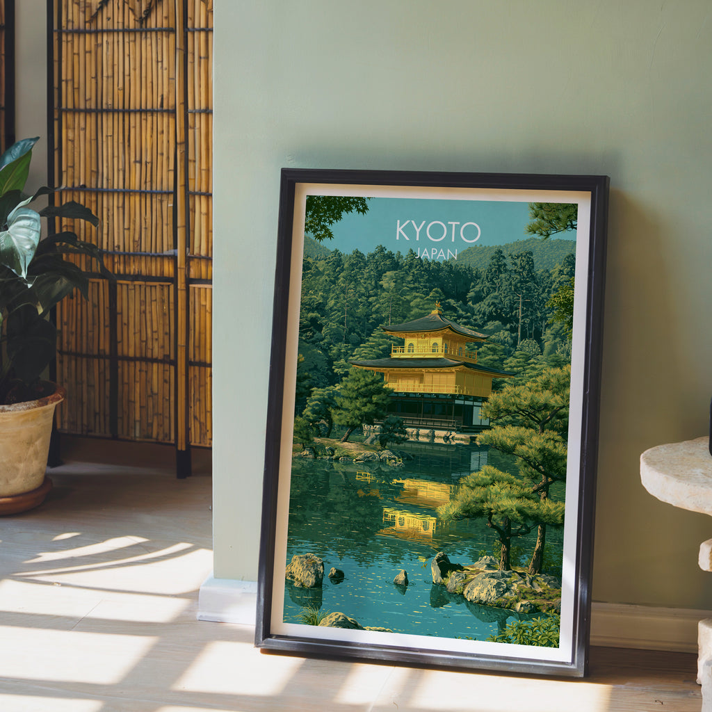 Kinkakuji Golden Pavilion Kyoto wall art in a black frame leaning against a sage green wall beside a bamboo screen