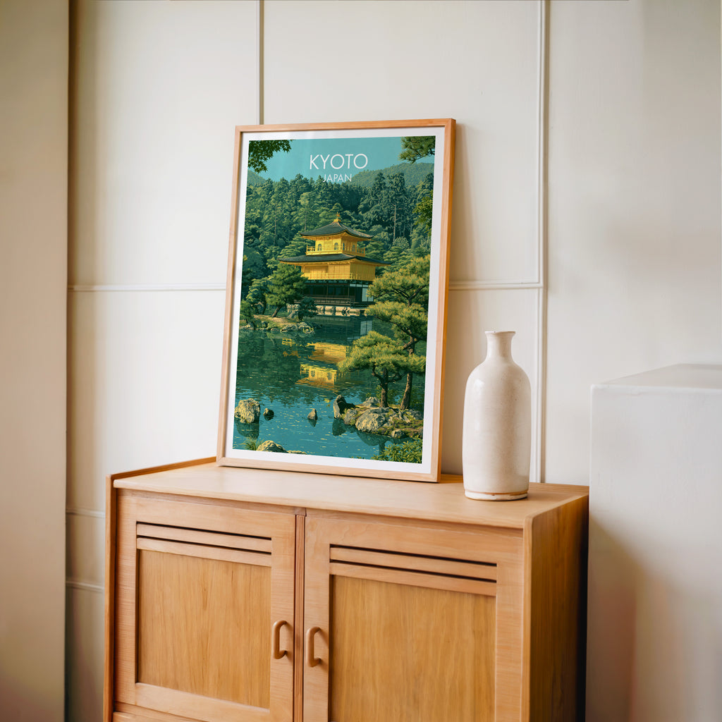 Small Kinkakuji Golden Pavilion Kyoto travel poster in an oak frame on a mid-century sideboard with a ceramic vase