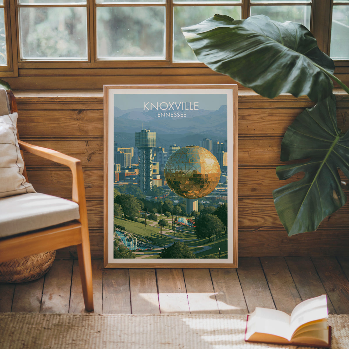 Knoxville park print in an oak frame on a sunlit wood-grain wall beside a mid-century armchair and rug.