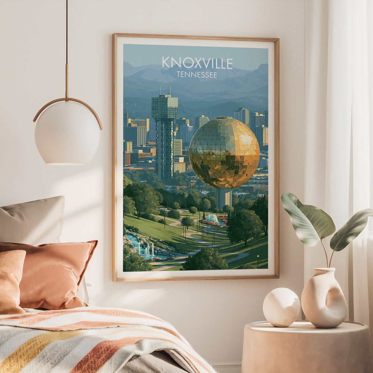 Large oak-framed Knoxville Sunsphere artwork above a bed with a rust throw and brass pendant lamp.