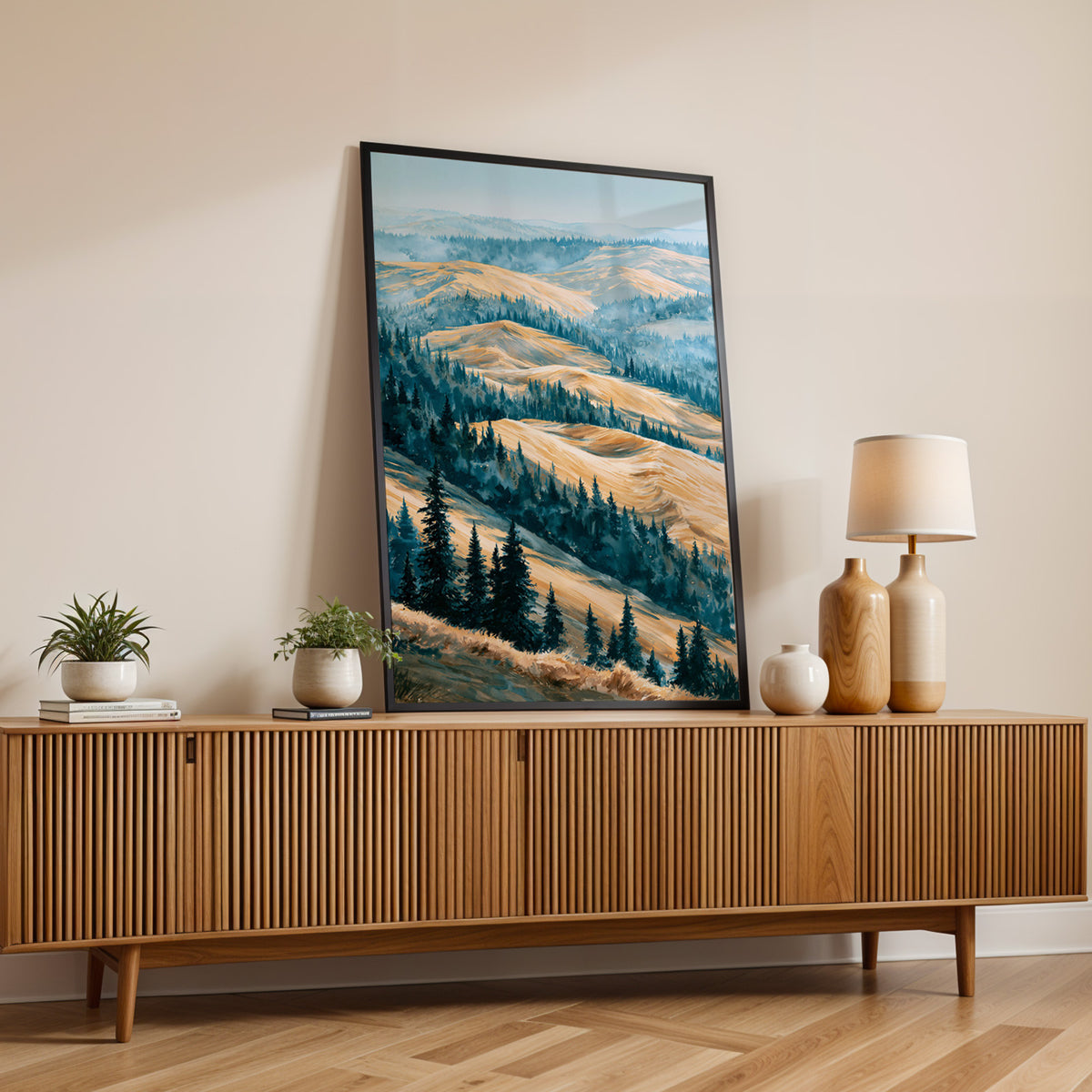 Kobuk Valley National Park watercolor print in a black frame on a fluted wood sideboard with a lamp and small plants