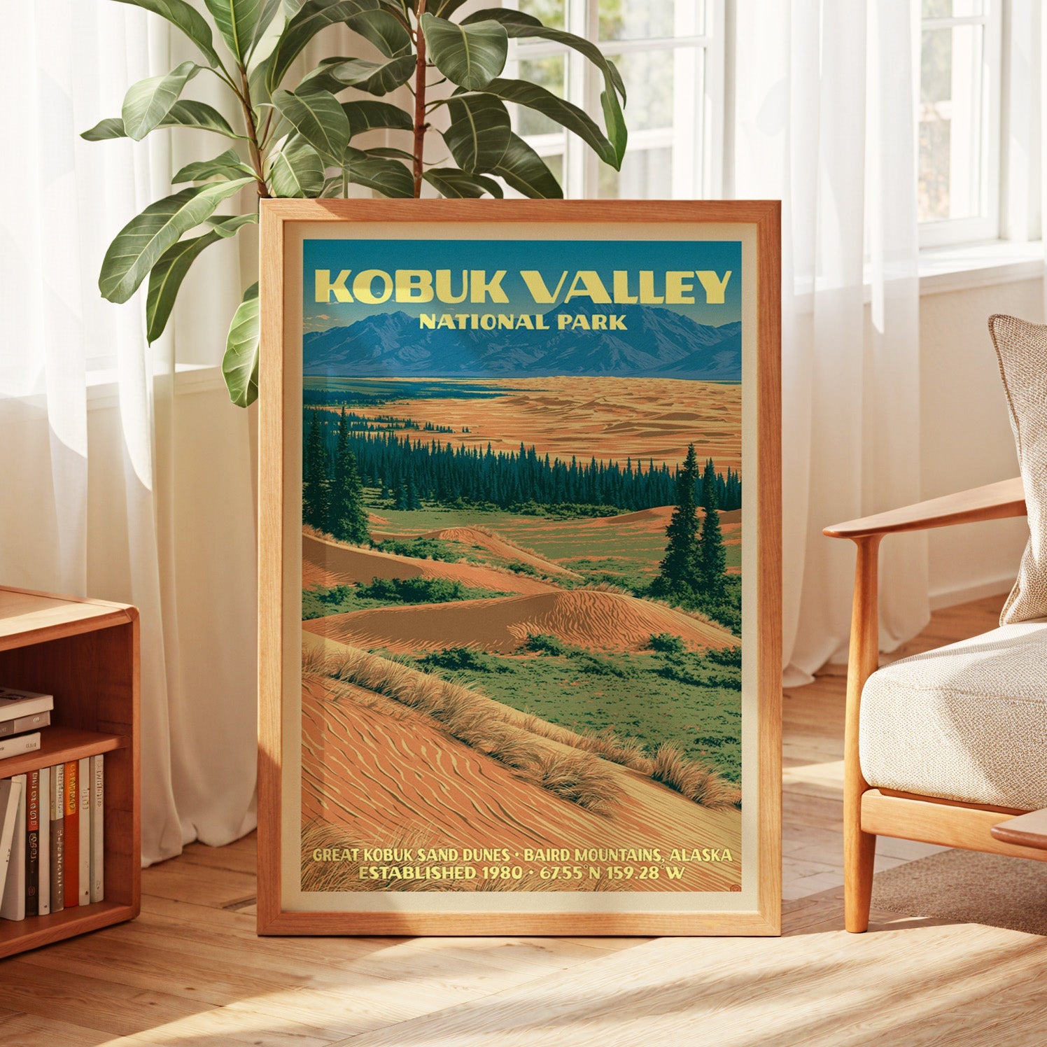 Kobuk Valley vintage poster in oak, leaning by a sunlit window with sheer curtains and a low bookshelf
