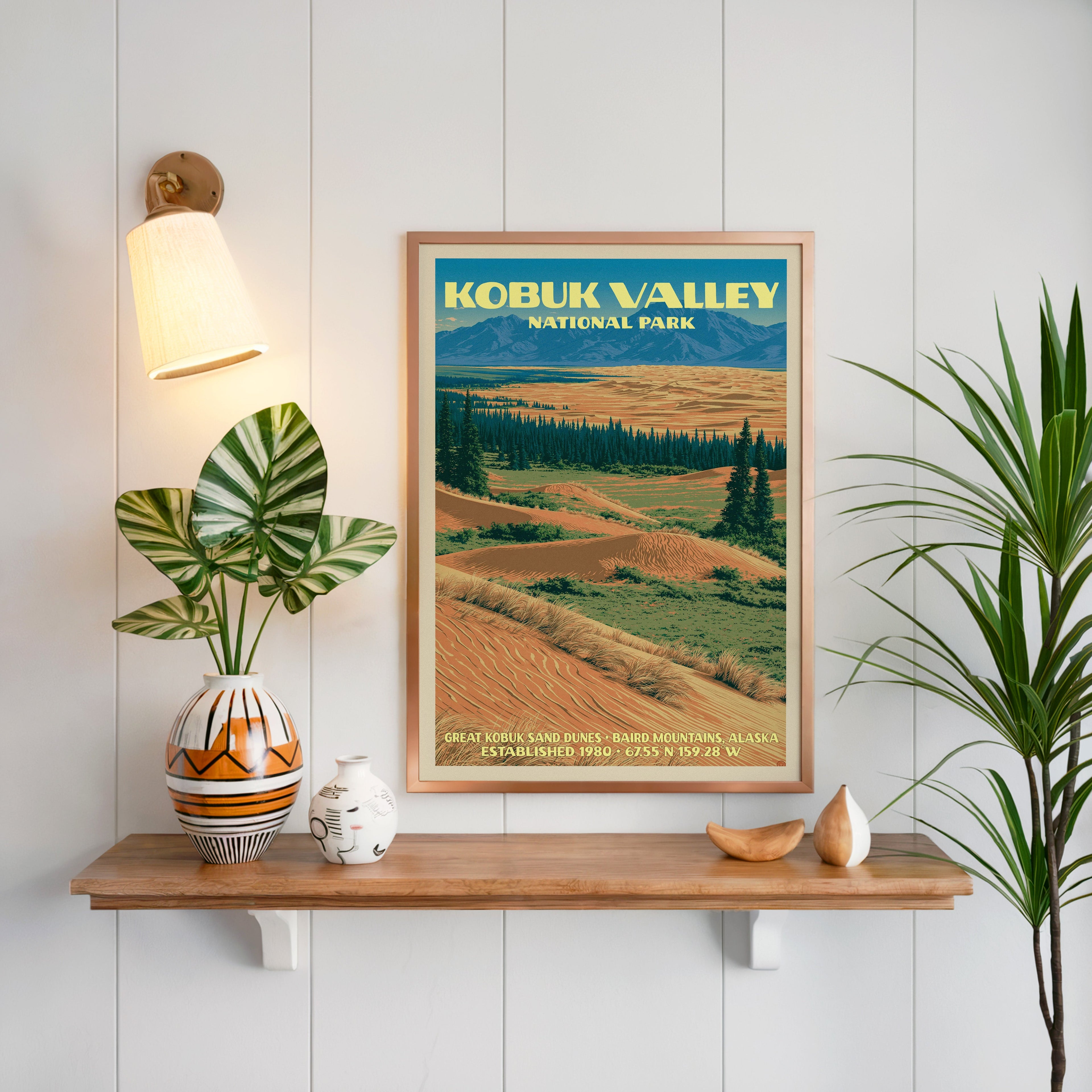 Great Kobuk Sand Dunes print framed on white panelling above an oak shelf with a patterned vase and sconce