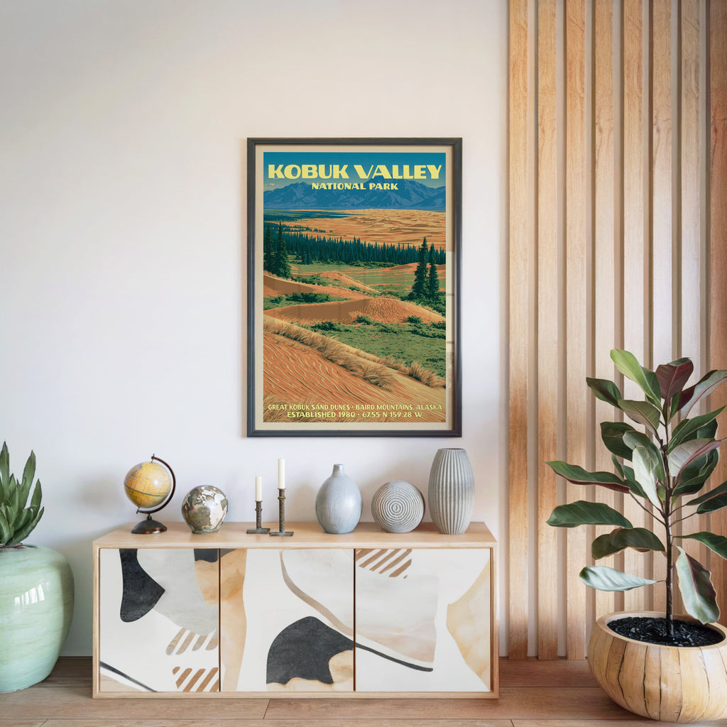 Kobuk Valley National Park poster in a black frame above a light wood sideboard by a slatted wall panel
