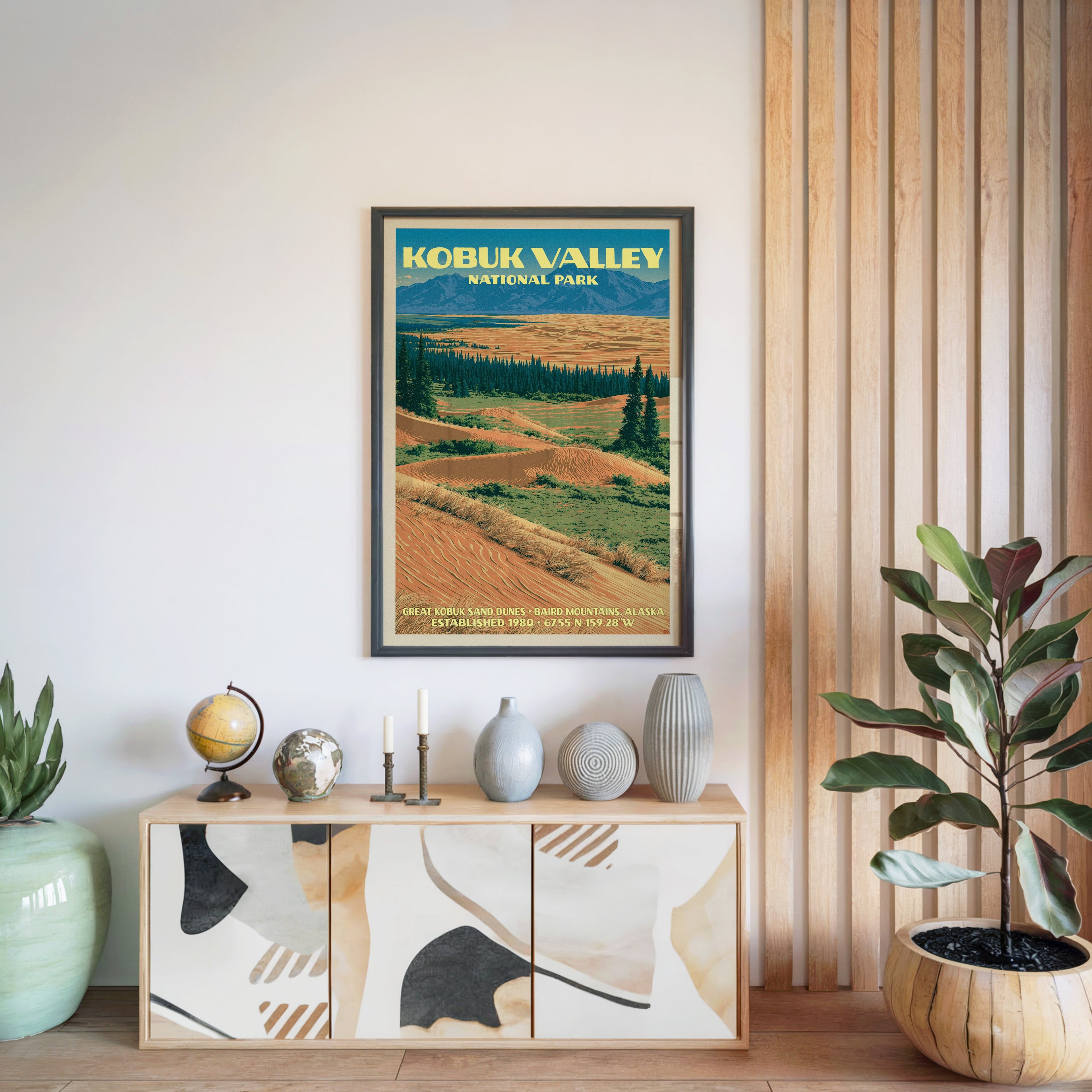 Kobuk Valley National Park poster in a black frame above a light wood sideboard by a slatted wall panel