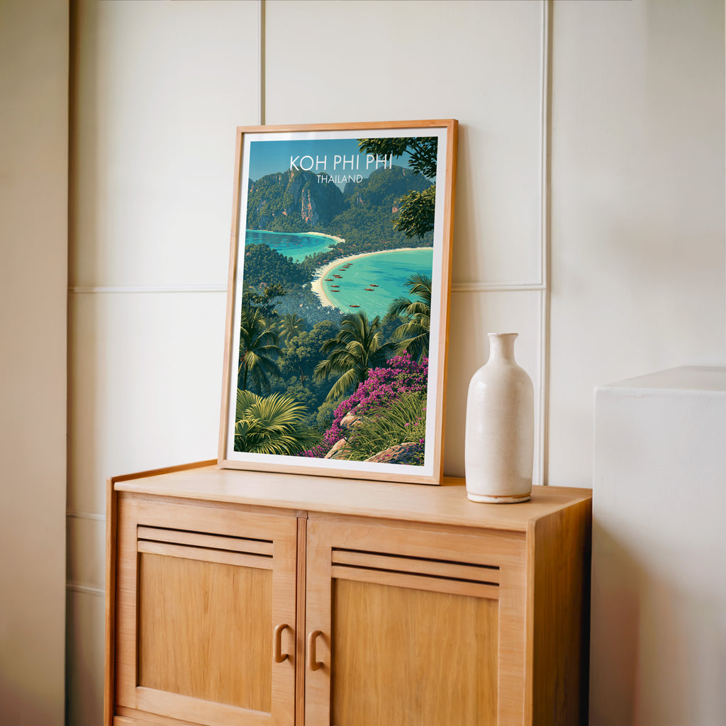Small Koh Phi Phi Thailand travel poster in an oak frame on a mid-century sideboard with a ceramic vase