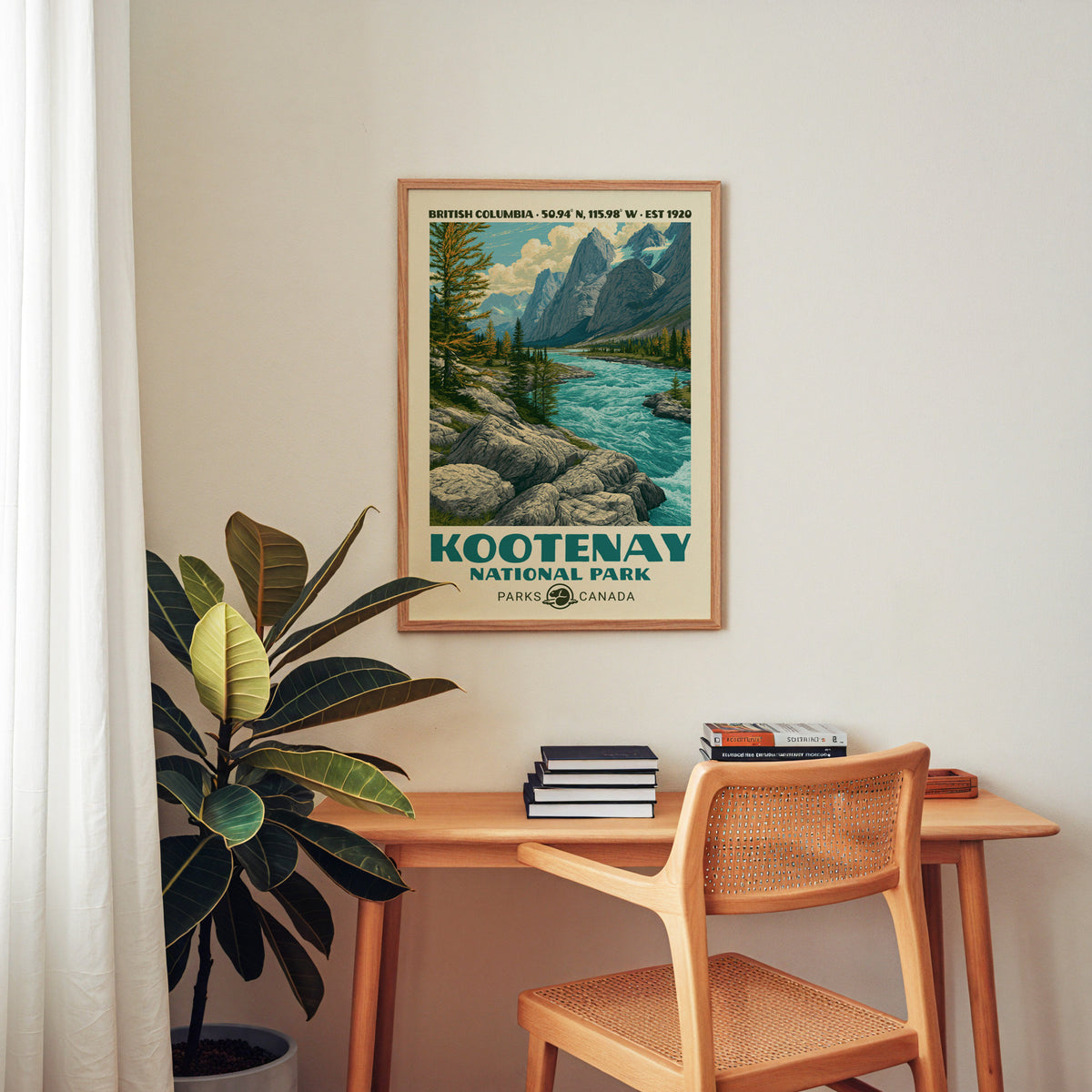 Kootenay Canada vintage poster in an oak frame above a wood desk with a cane chair