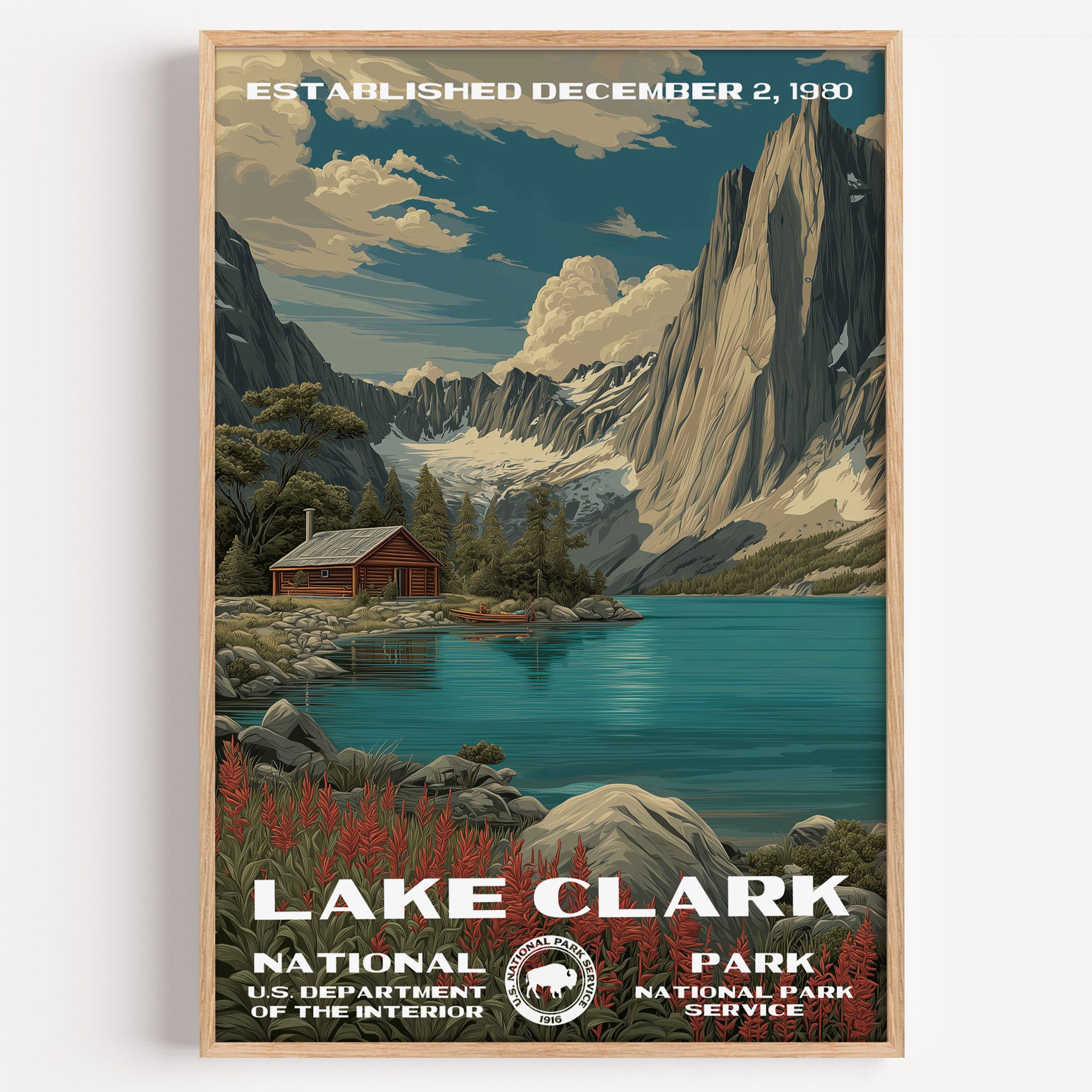 Lake Clark National Park vintage travel poster in a wood frame, a red cabin on a turquoise lake below jagged snowy peaks