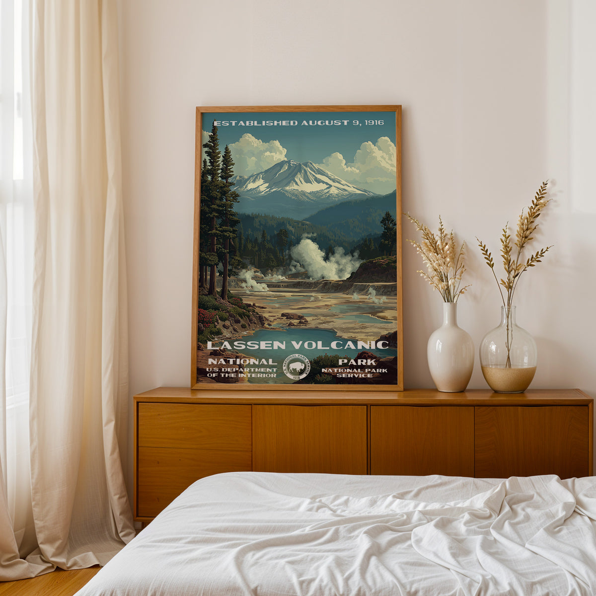 Lassen Volcanic National Park retro poster above a walnut sideboard in a bright linen bedroom