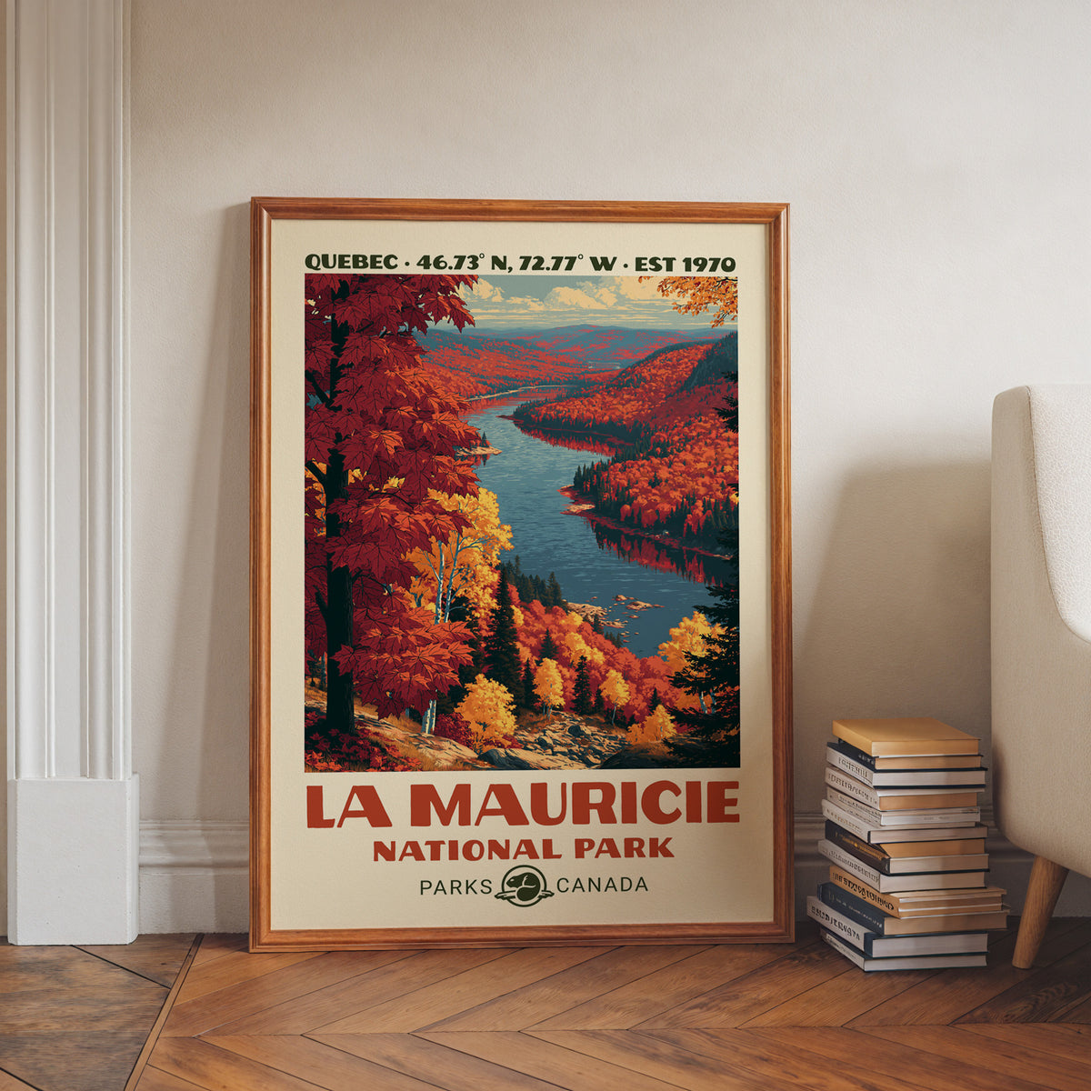 Quebec autumn river wall art in a walnut frame on a herringbone floor beside stacked books