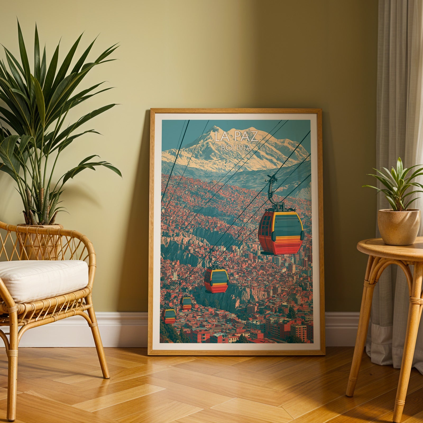 Andean capital print in an oak frame on a herringbone floor against an olive wall with a rattan chair and tall palm