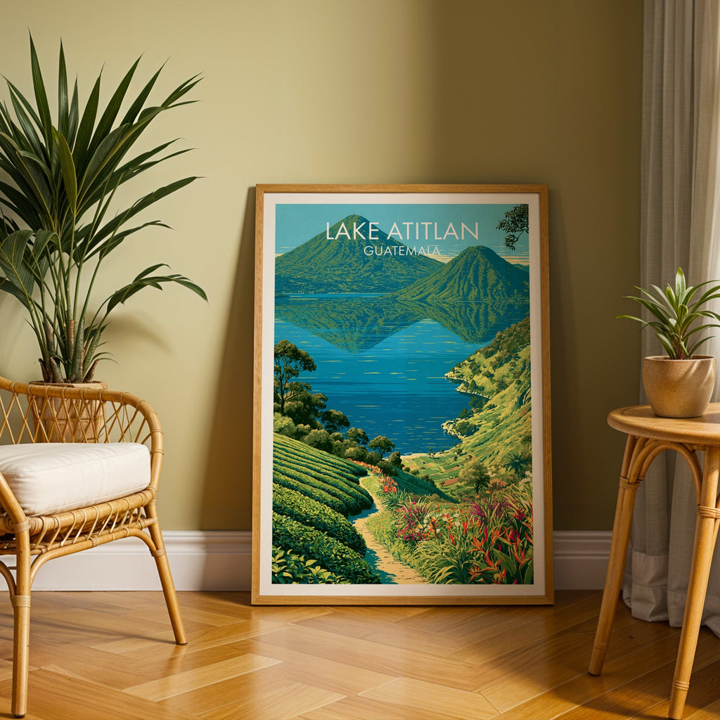 Jade and cobalt lake scene in an oak frame leaning on herringbone parquet, olive wall, rattan chair and cane table