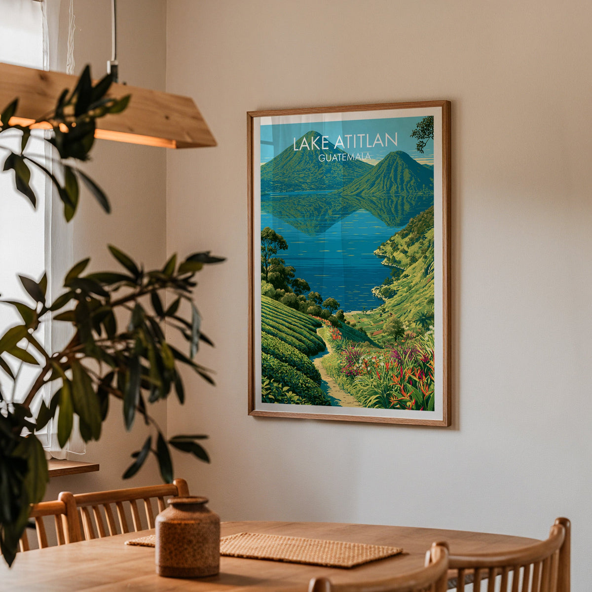 Guatemala lake and volcanoes in an oak frame in a dining corner with spindle chairs and a wood pendant lamp