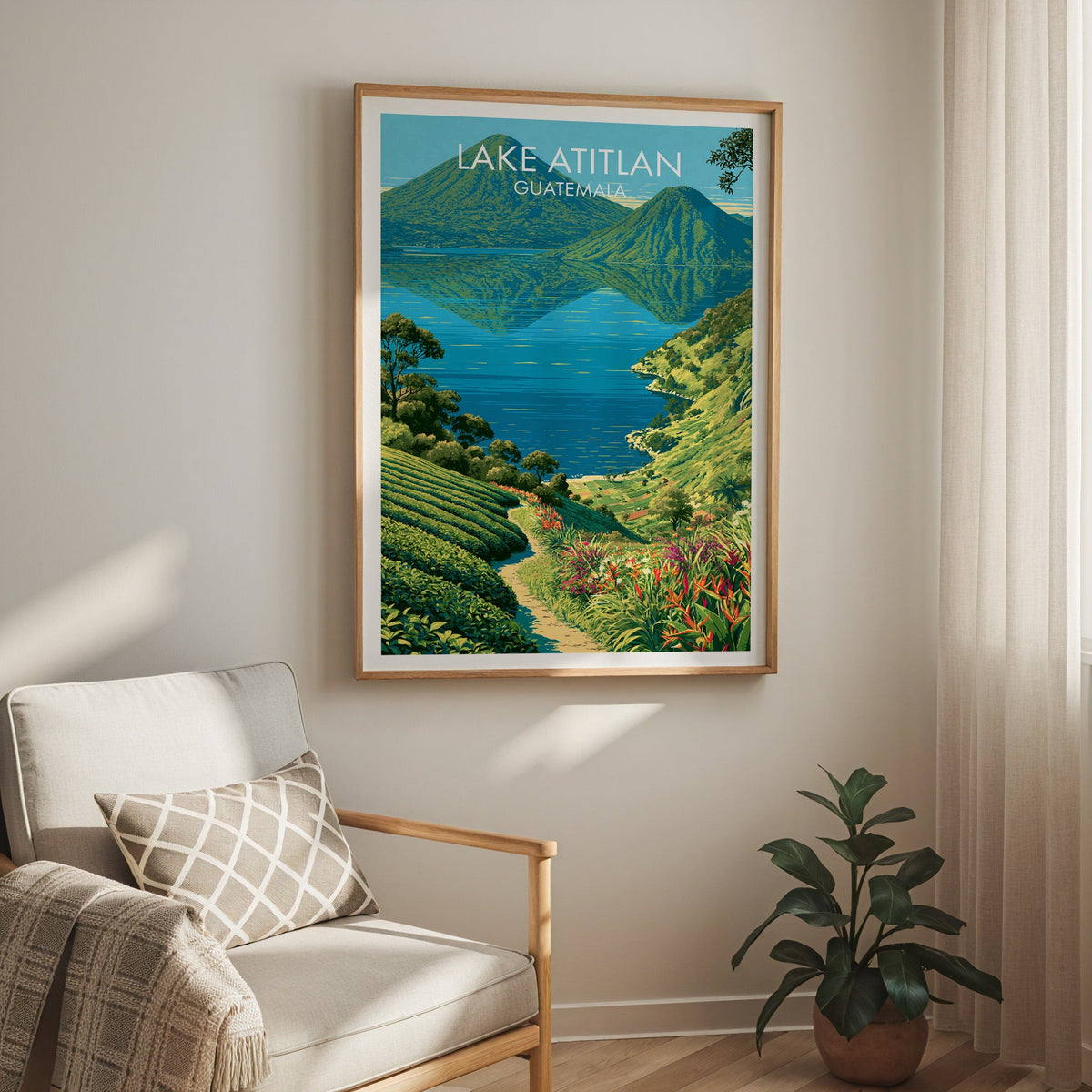Turquoise sky and forested peaks, oak frame above a cream armchair with a check cushion and a sheer curtain