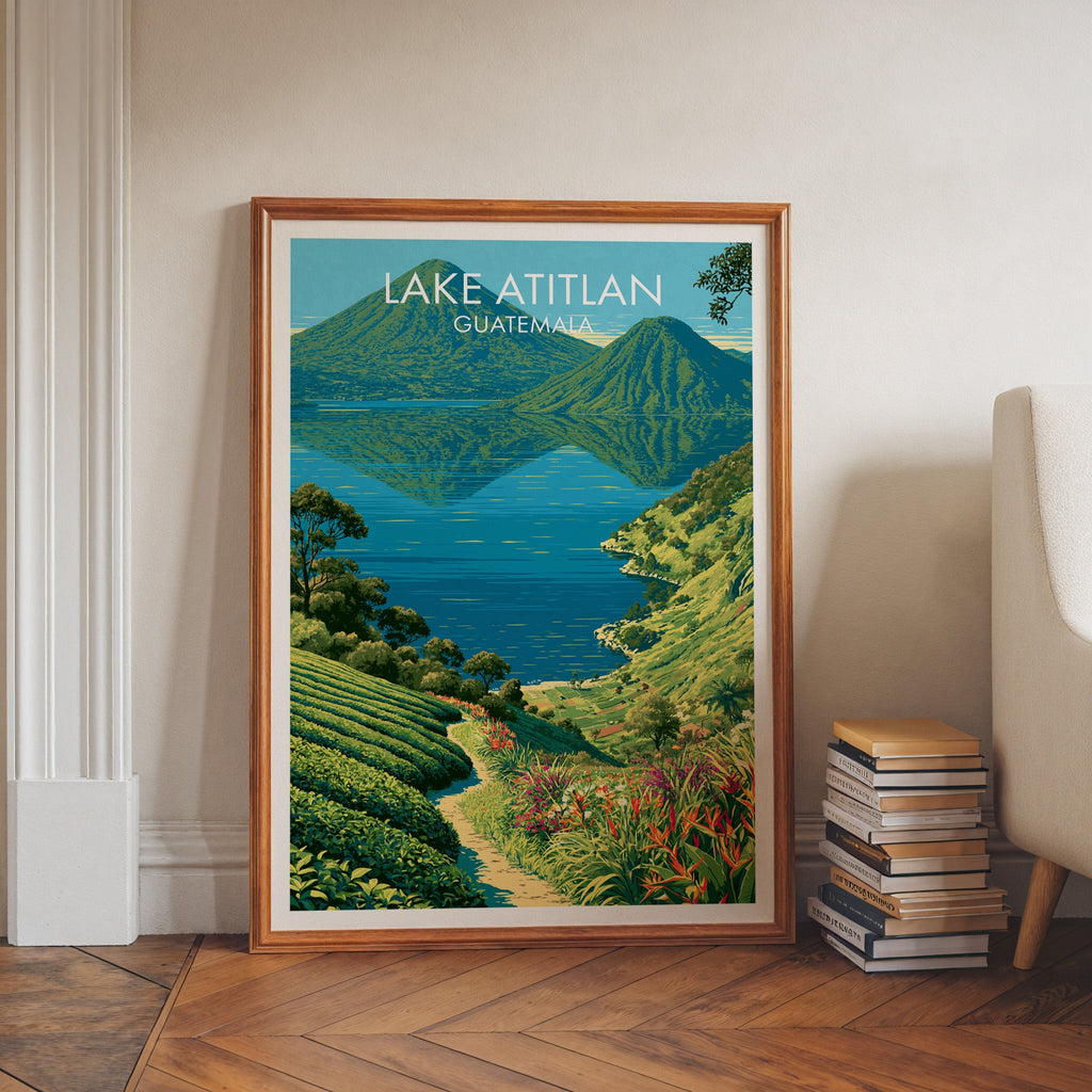 Terraced slopes above blue water, walnut frame leaning on herringbone floor beside stacked books and an armchair