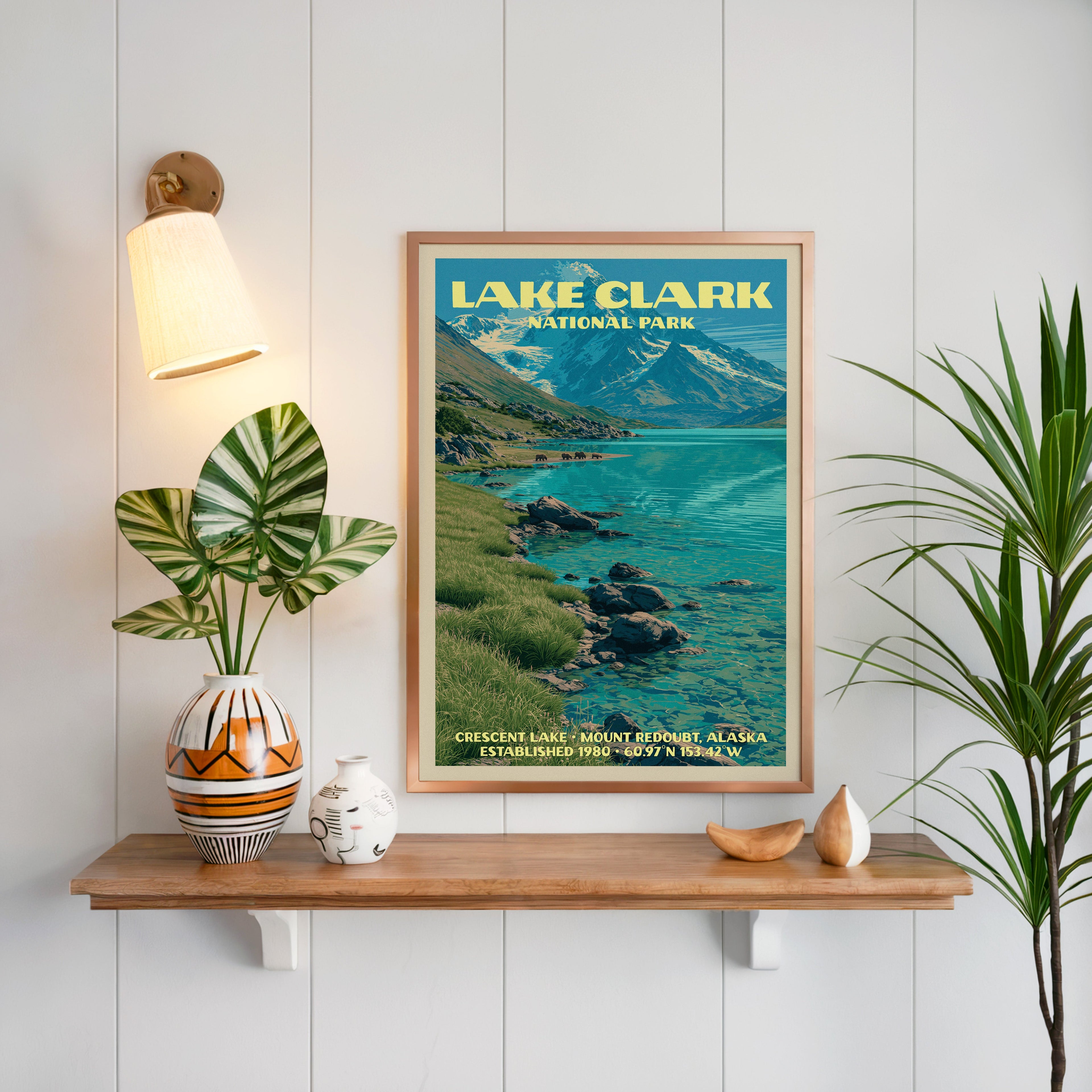 Crescent Lake Lake Clark print framed on white panelling above an oak shelf with a patterned vase and sconce