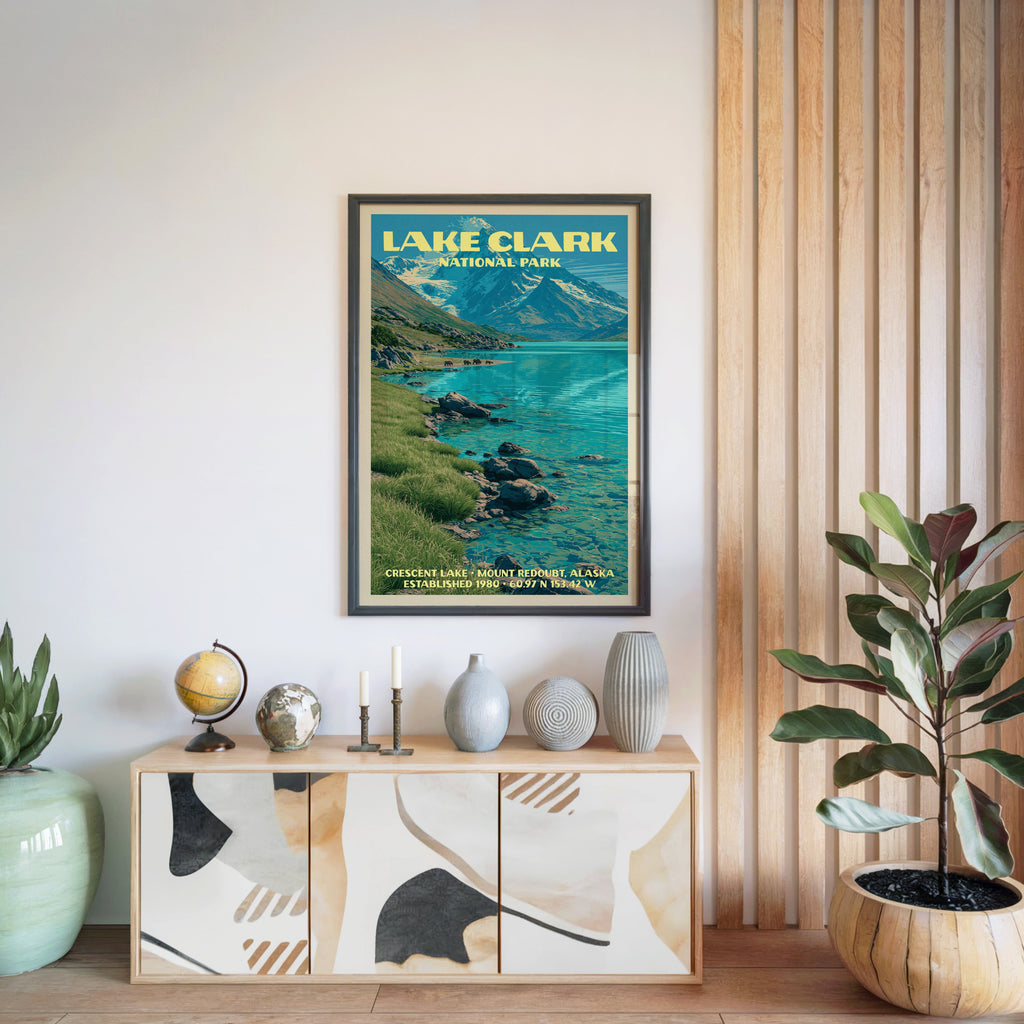 Lake Clark National Park poster in a black frame above a light wood sideboard by a slatted wall panel