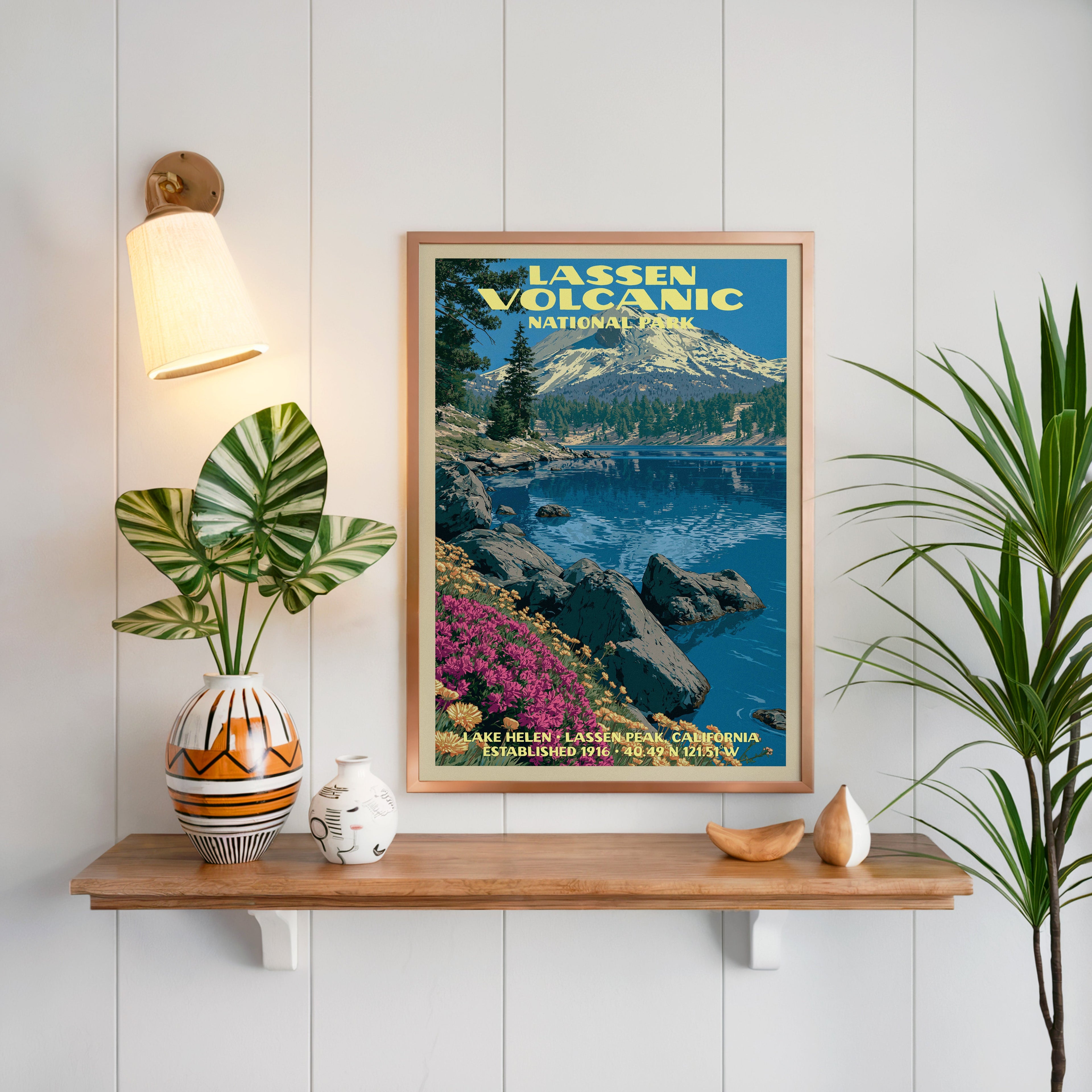 Lake Helen Lassen Volcanic print framed on white panelling above an oak shelf with a patterned vase and sconce