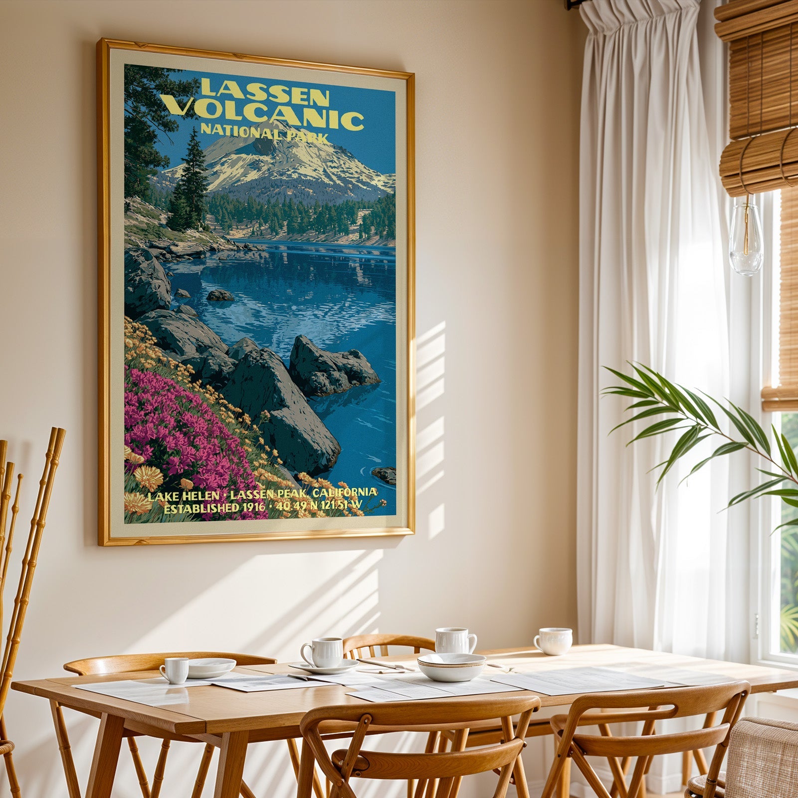 Lassen Volcanic National Park print in gold above a light oak dining table by a curtained window