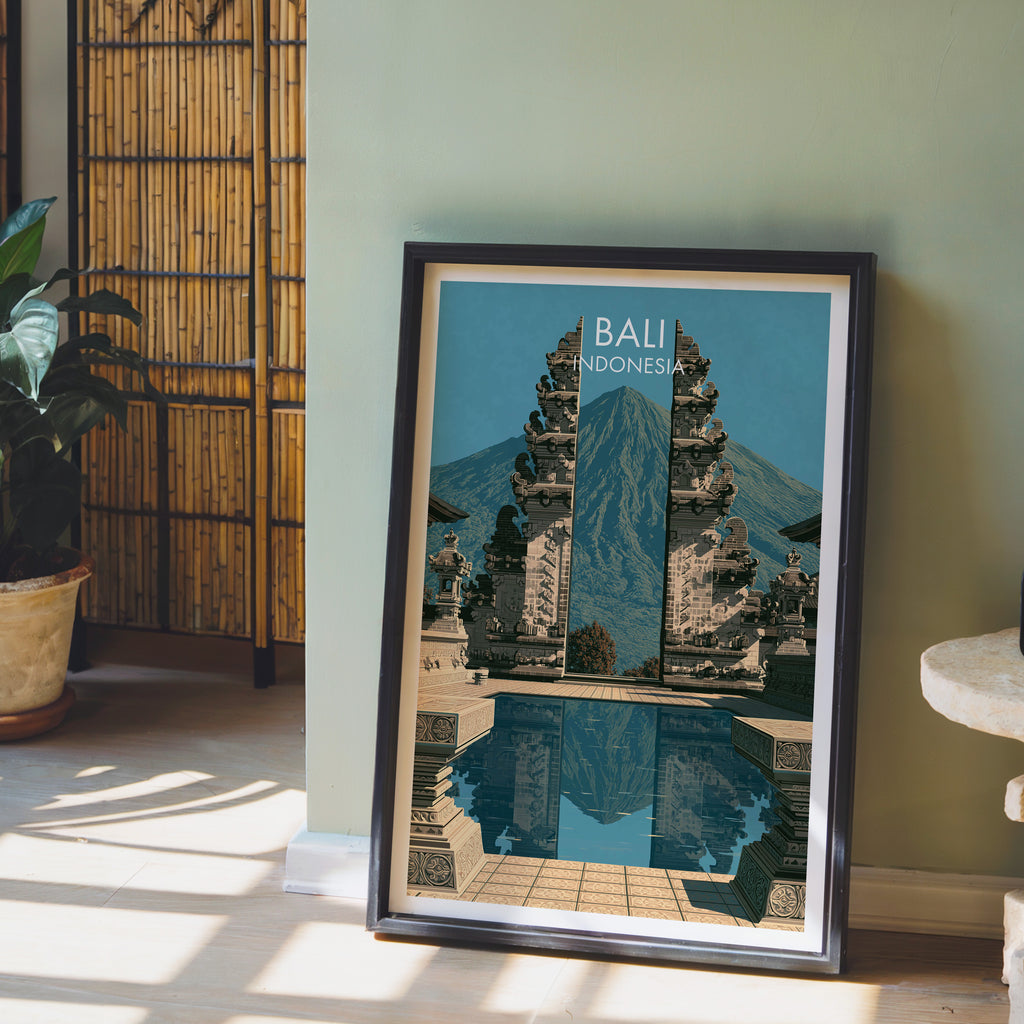 Lempuyang Temple Bali Indonesia wall art in a black frame leaning against a sage green wall beside a bamboo screen