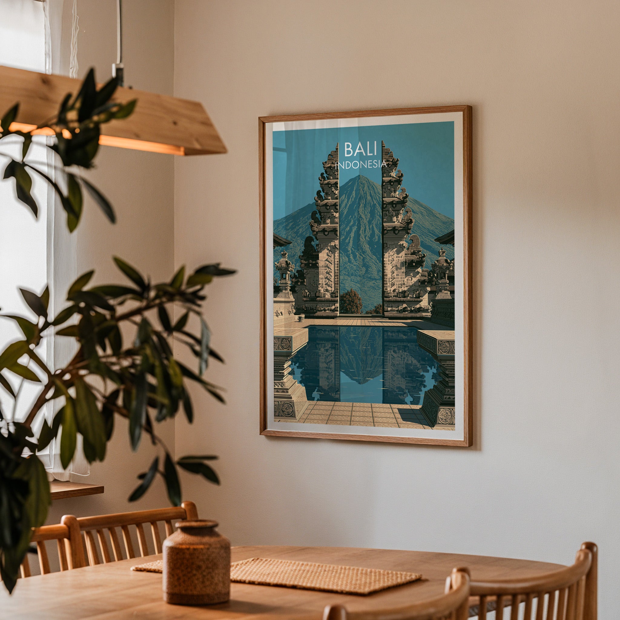 Framed Lempuyang Temple Bali Indonesia print on a dining room wall above an oak table in warm afternoon light