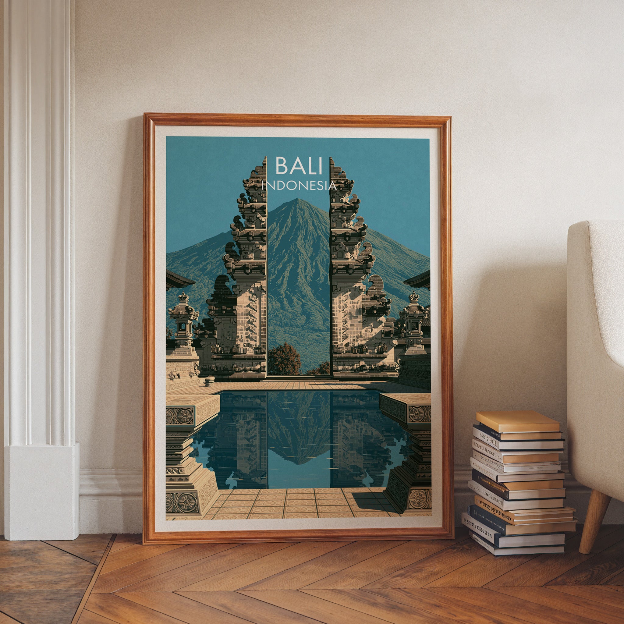 Lempuyang Temple Bali Indonesia art print in a walnut frame leaning in a hallway beside stacked books