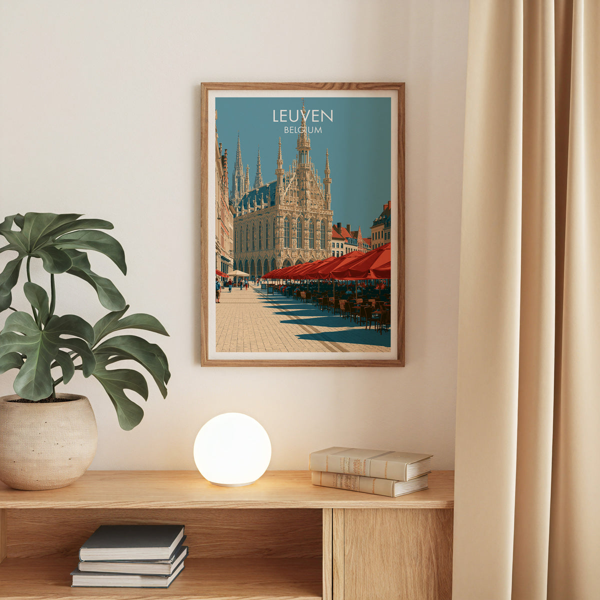 Leuven town hall print, oak frame above an oak console with a monstera and a round globe lamp