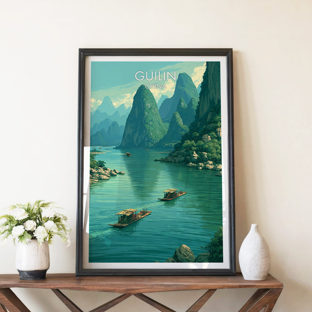 Li River Guilin China travel poster in a black frame on a wooden console table with white flowers