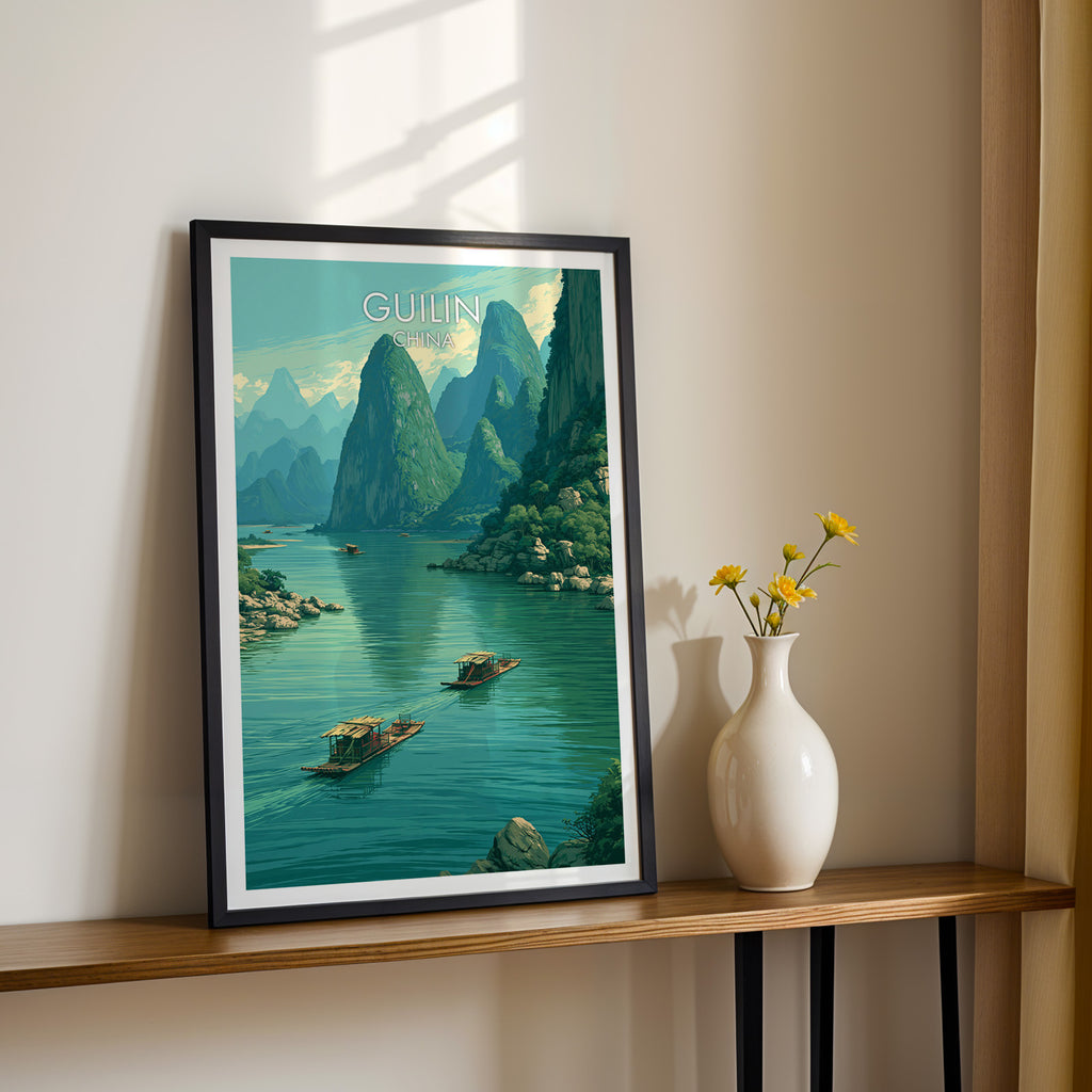 Black framed Li River Guilin China print on a narrow hallway console in sunlight, styled with yellow flowers