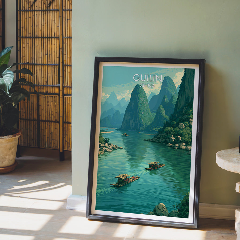 Li River Guilin China wall art in a black frame leaning against a sage green wall beside a bamboo screen