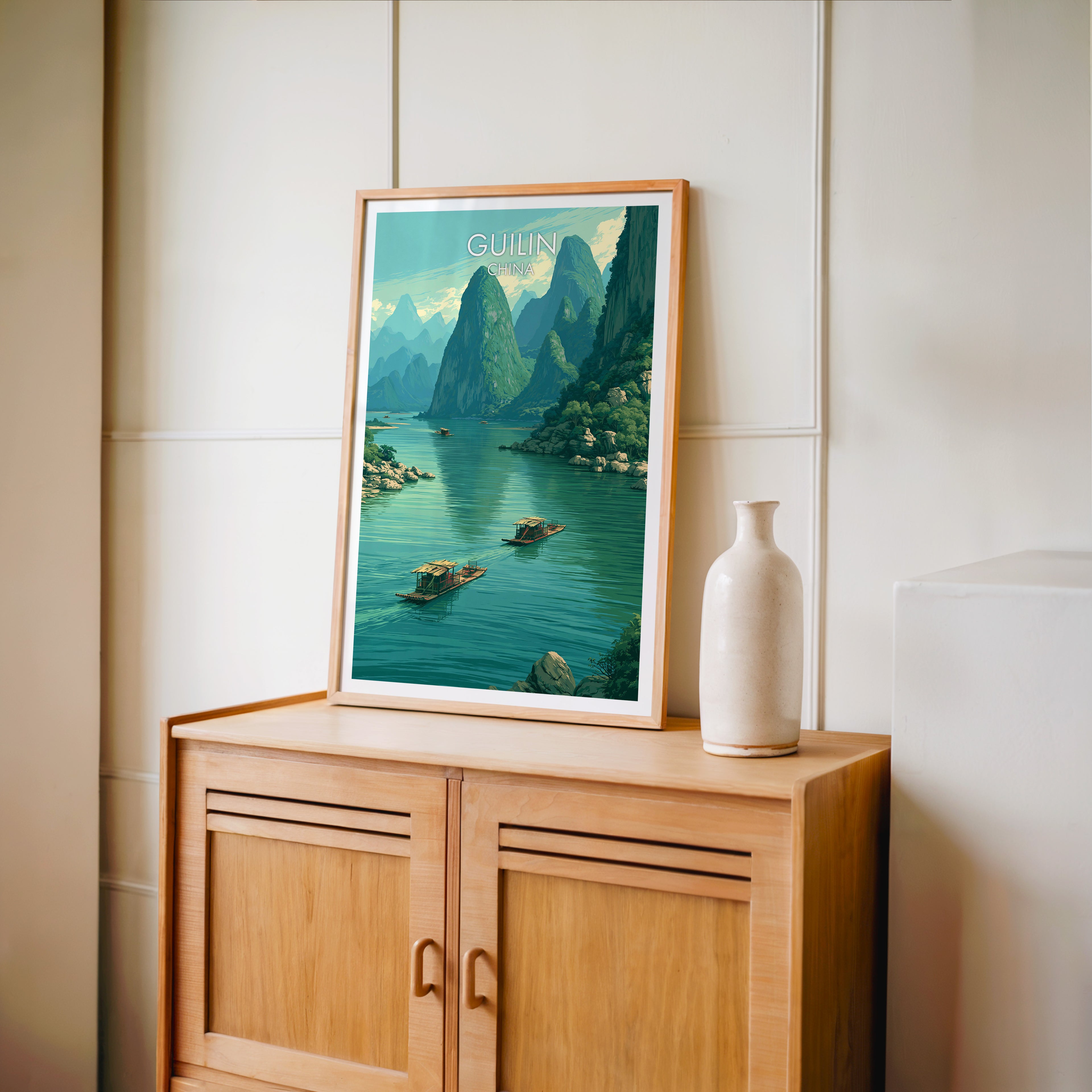Small Li River Guilin China travel poster in an oak frame on a mid-century sideboard with a ceramic vase