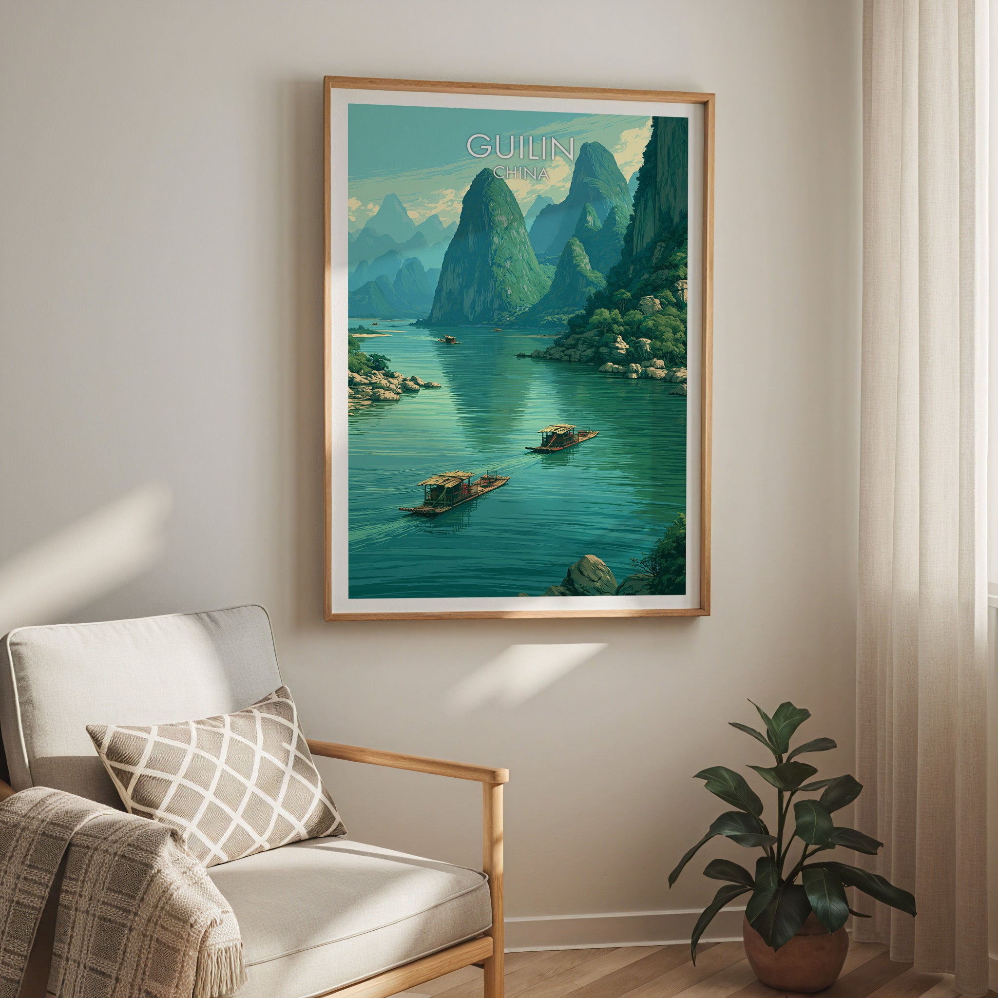 Li River Guilin China travel print in a light oak frame on a living room wall beside a linen armchair