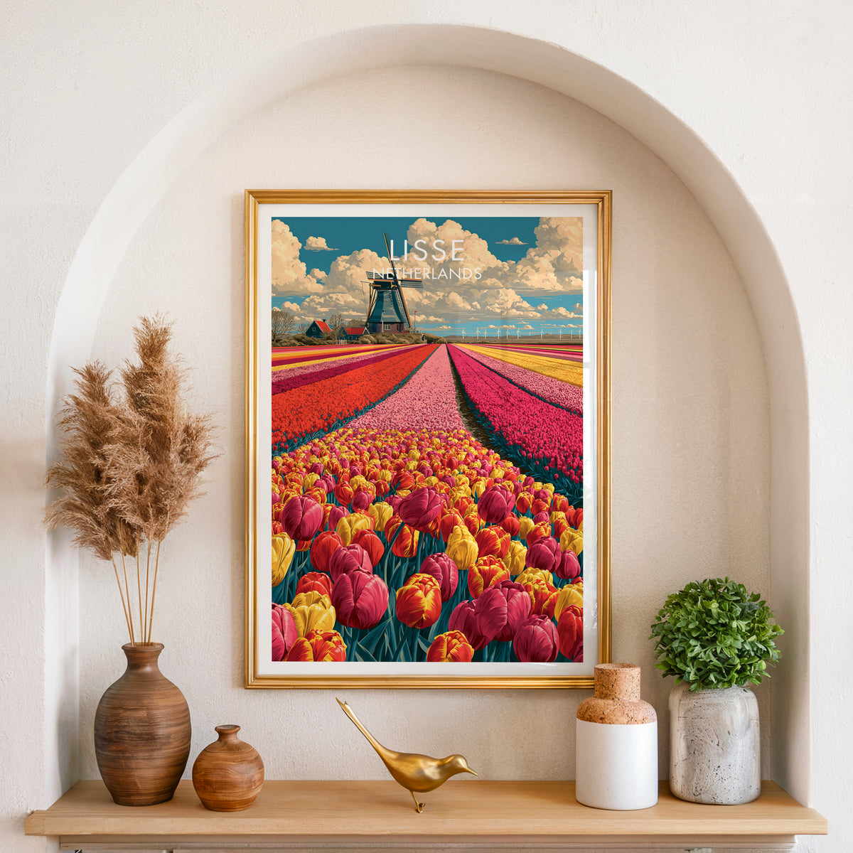 Lisse tulip fields print in a gold frame in an arched plaster alcove with pampas grass and a brass bird