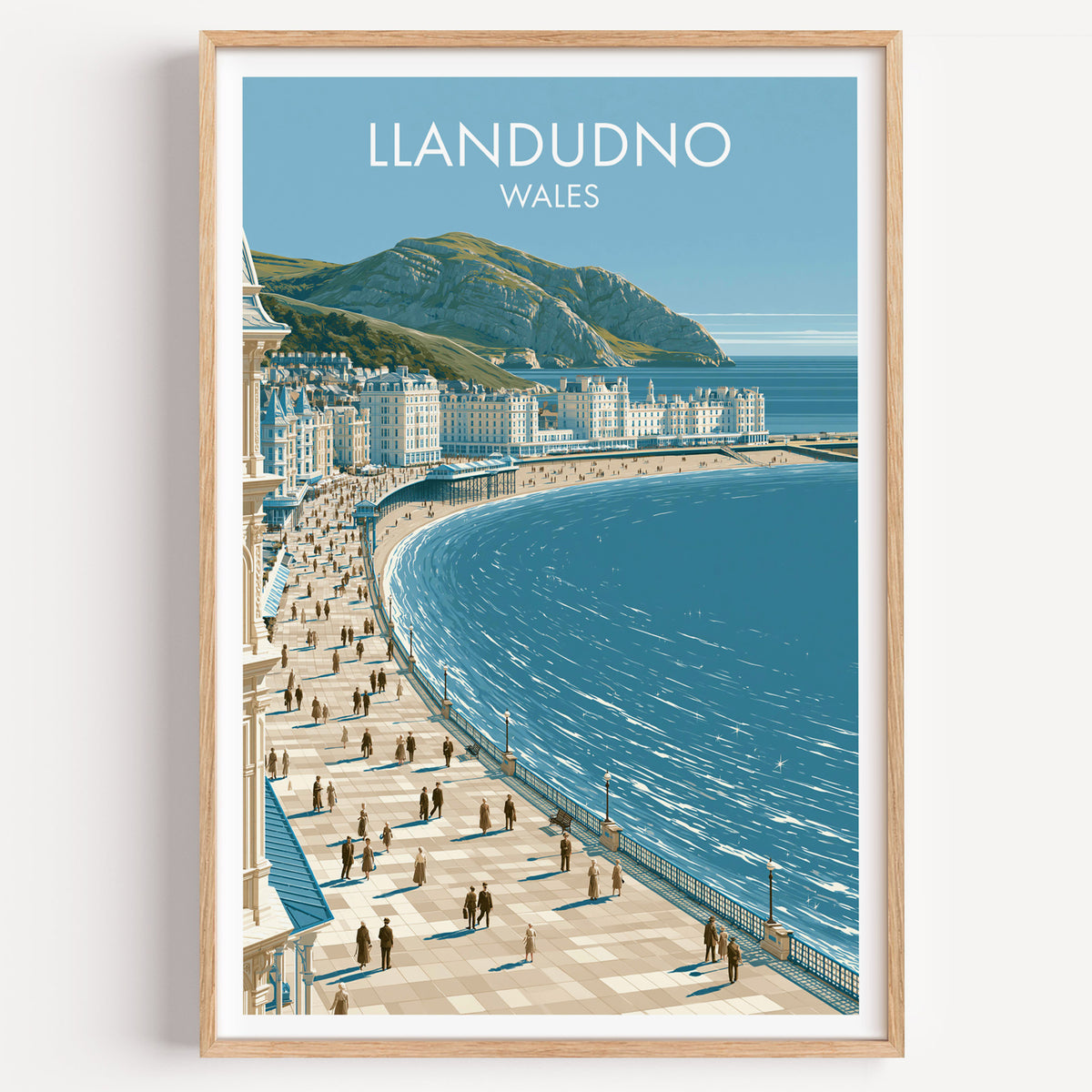 Llandudno Great Orme poster, gold frame in an arched wall niche above pampas grass in a clay vase