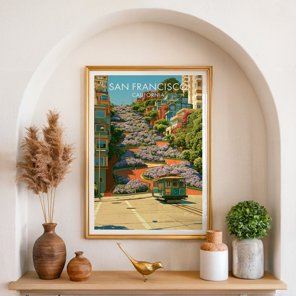 San Francisco hillside wall art in a gold frame in an arched niche with pampas and a brass bird