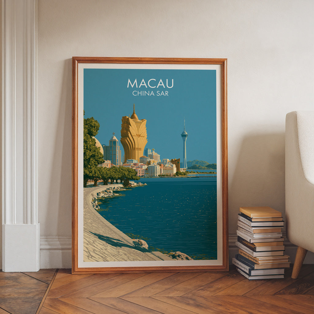 Macau China art print in a walnut frame leaning in a hallway beside stacked books