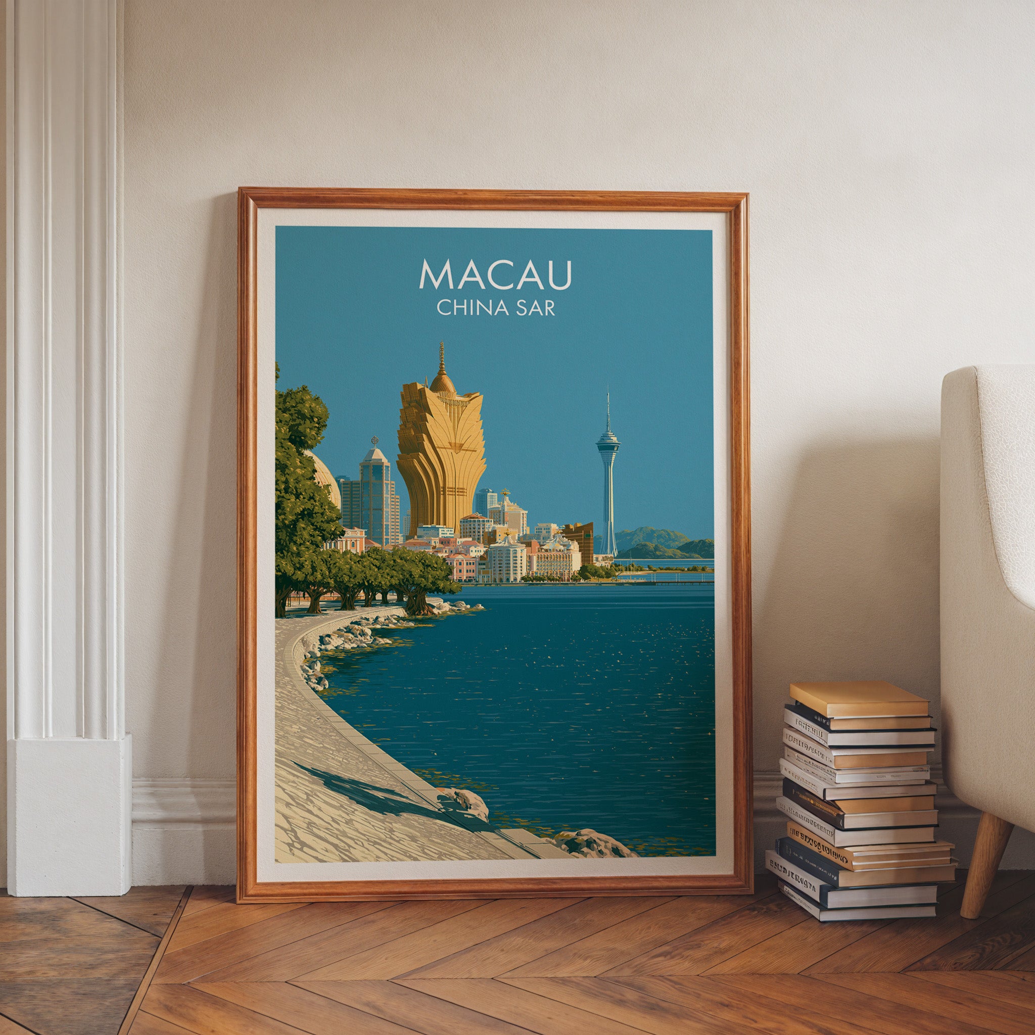 Macau China art print in a walnut frame leaning in a hallway beside stacked books
