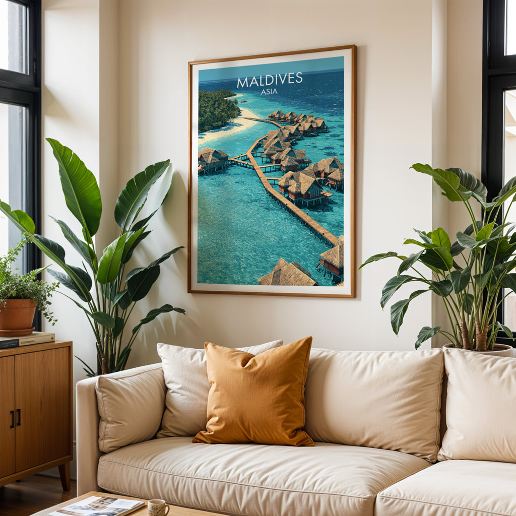 Framed Maldives wall art hanging above a cream sofa in a bright living room with tropical plants