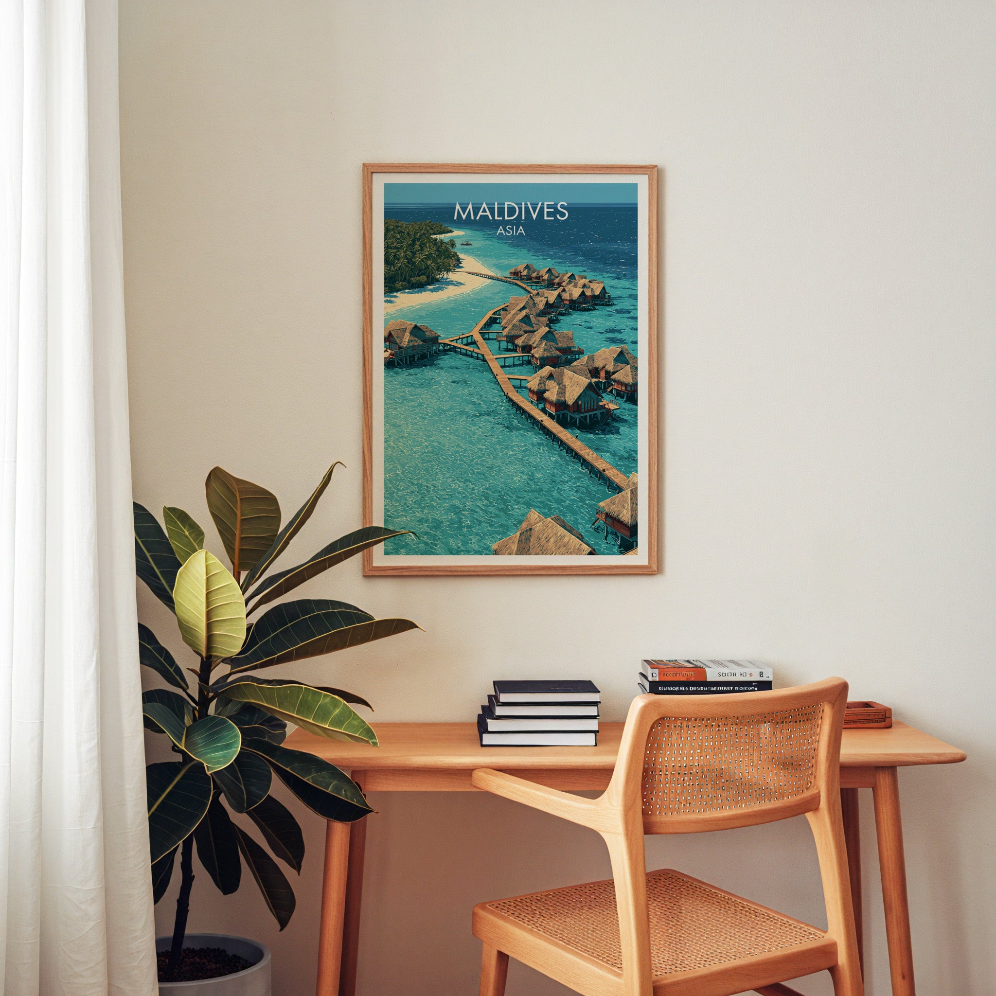 Maldives wall art above a wooden home office desk with a rattan chair and books