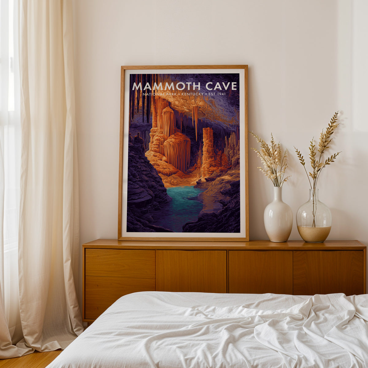 Mammoth Cave National Park mid-century modern art print framed in oak on a walnut credenza beside a linen-dressed bed — bedroom wall art